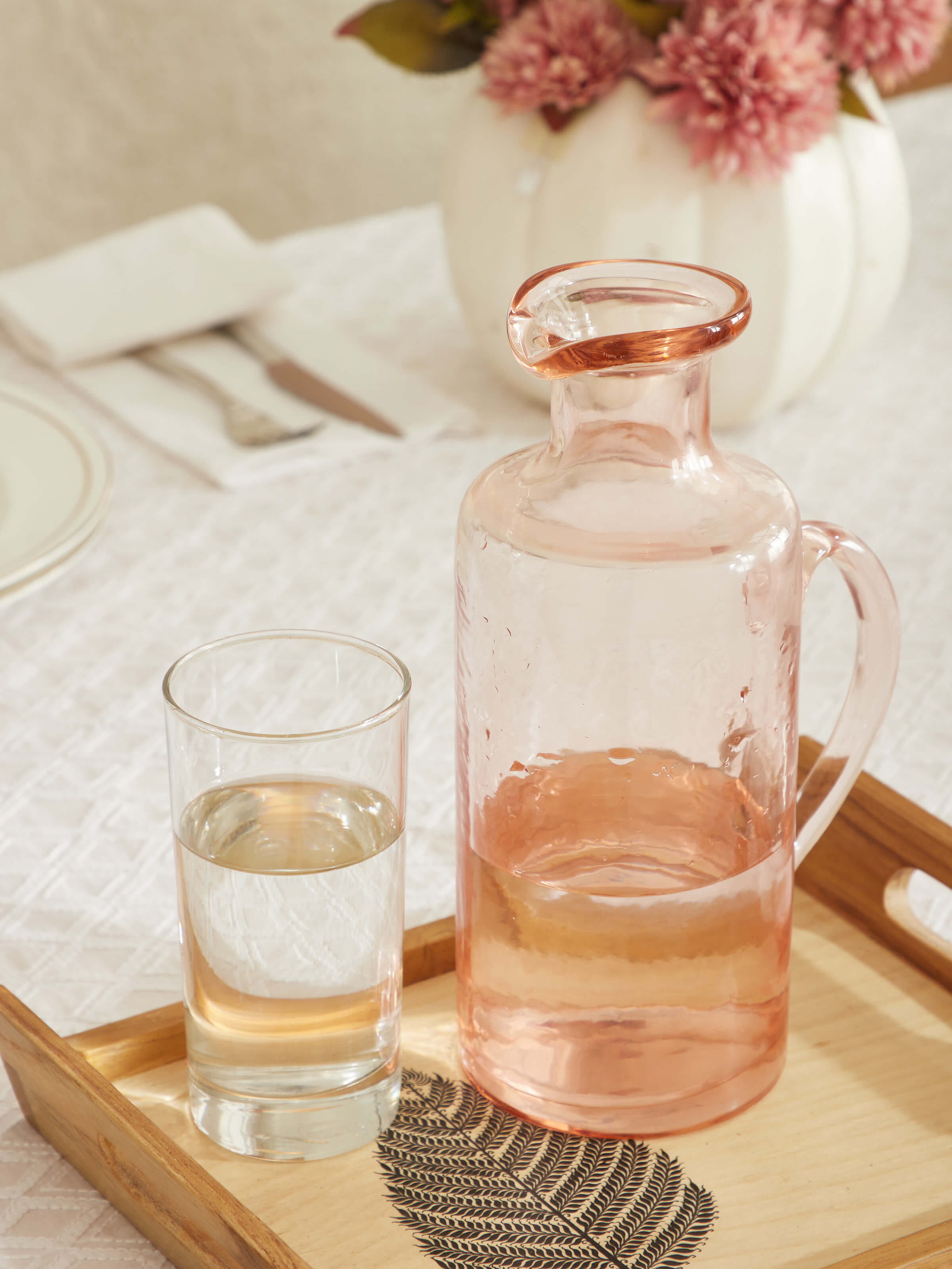Close-up view of Firozabadi glass pitcher in pink, focusing on the detailing of the glass.