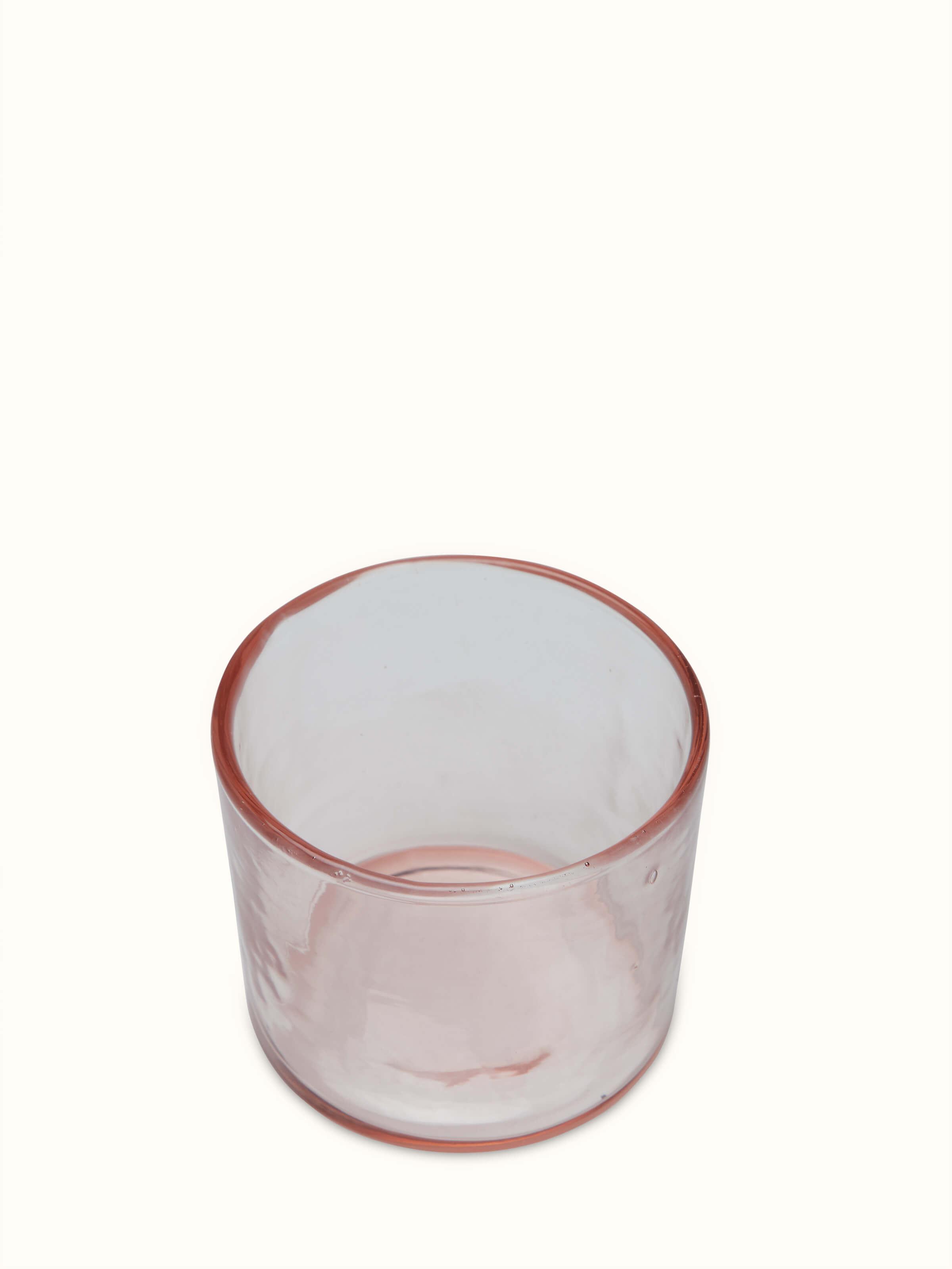 Side view of Firozabadi Glass Carafe (Pink) emphasizing its elegant curve.