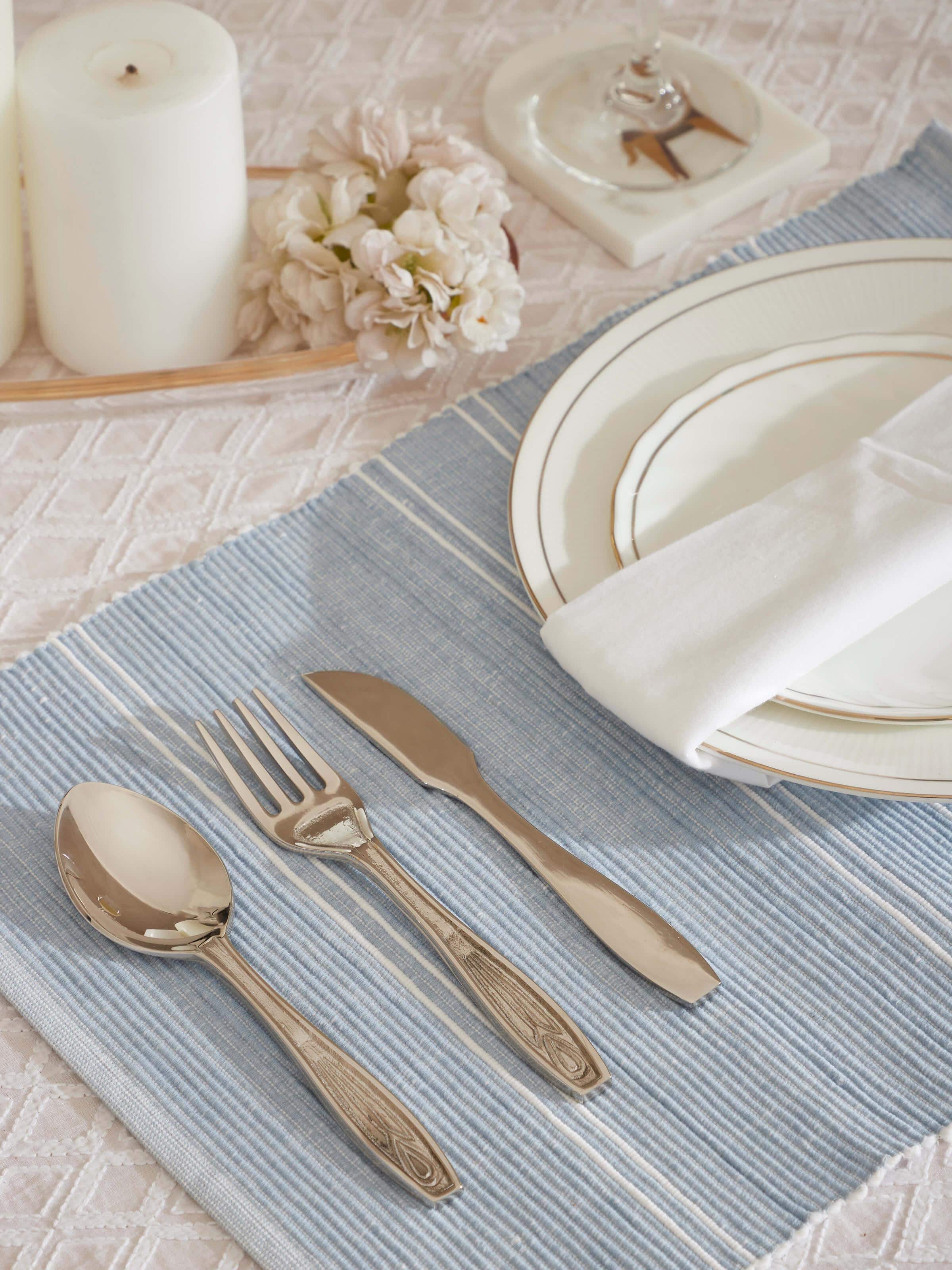 Side view of Nakkashi brass cutlery set showing detailed craftsmanship