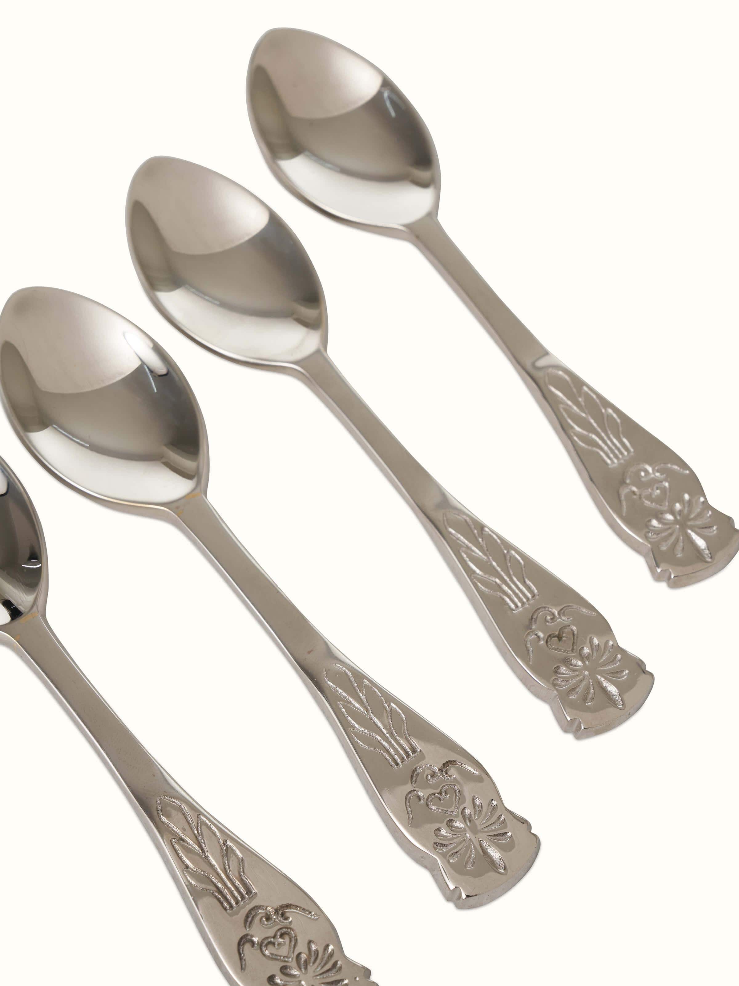 Angled view of brass teaspoons, showing their elegant design and functional features.
