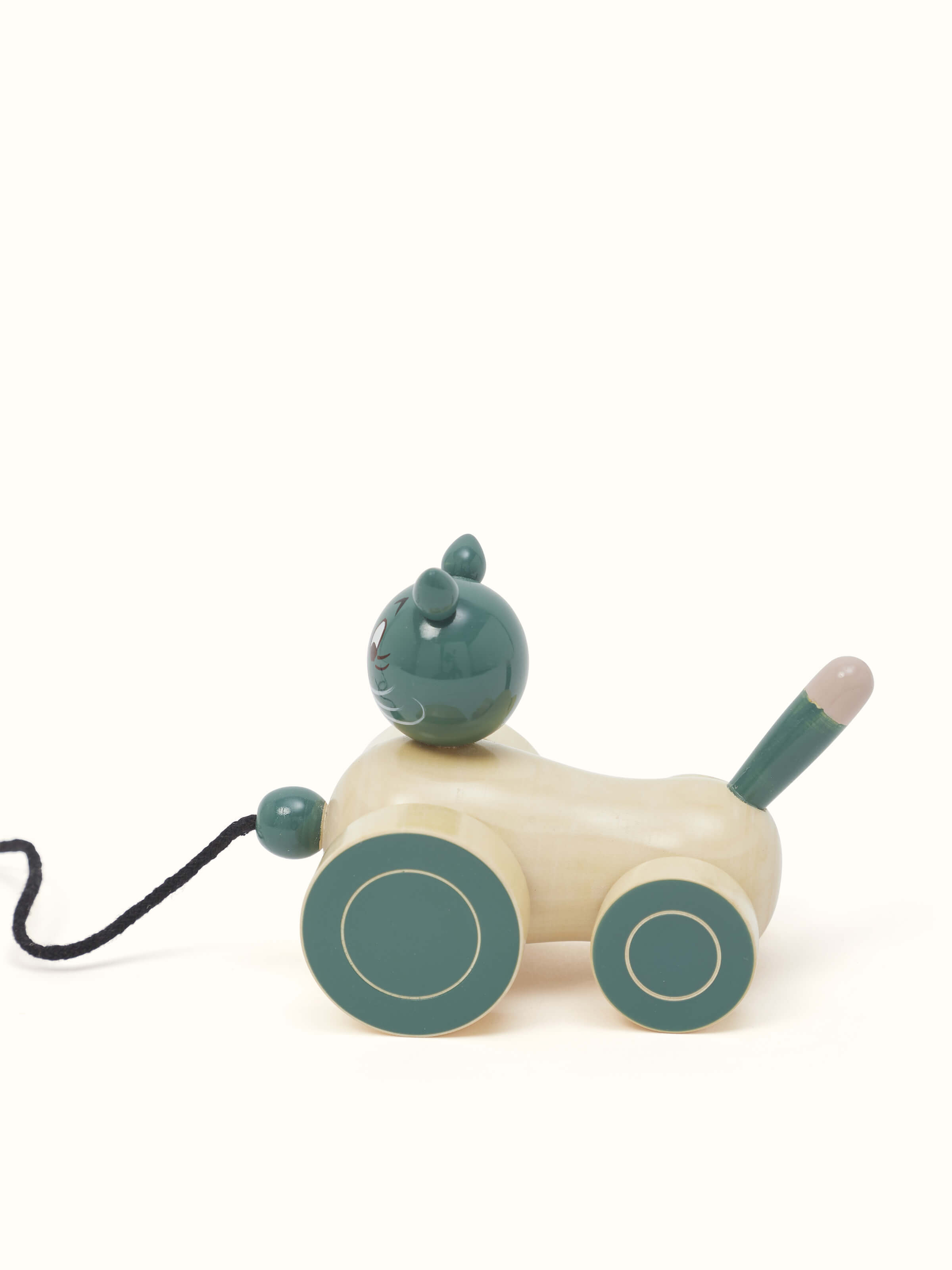 Side view of Channapatna Ivory Wood Cat Pulling Toy in Off-White, highlighting the smooth finish and playful design