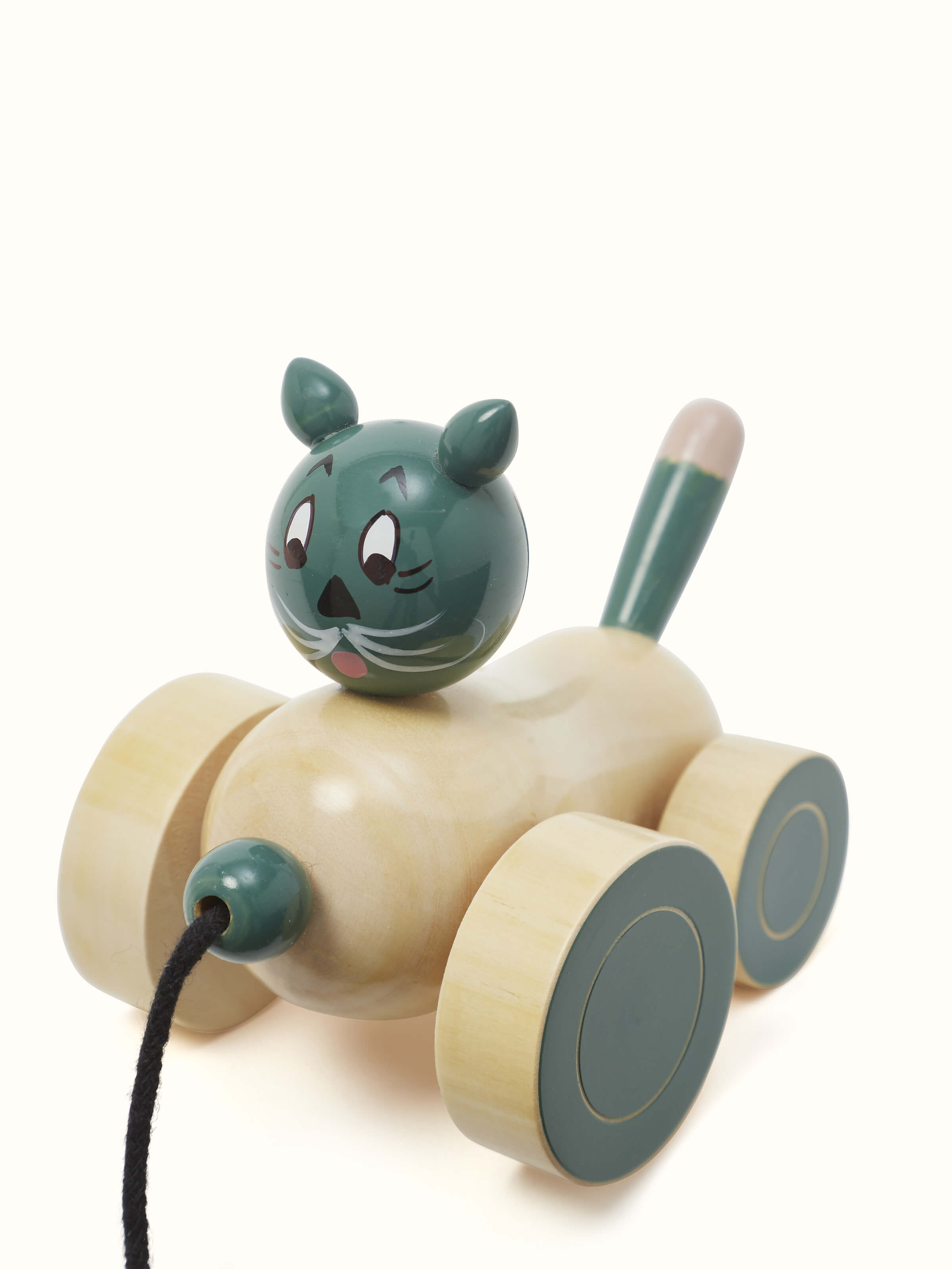 Artistic view of Channapatna Ivory Wood Cat Pulling Toy in Off-White, showing the toy from a unique angle