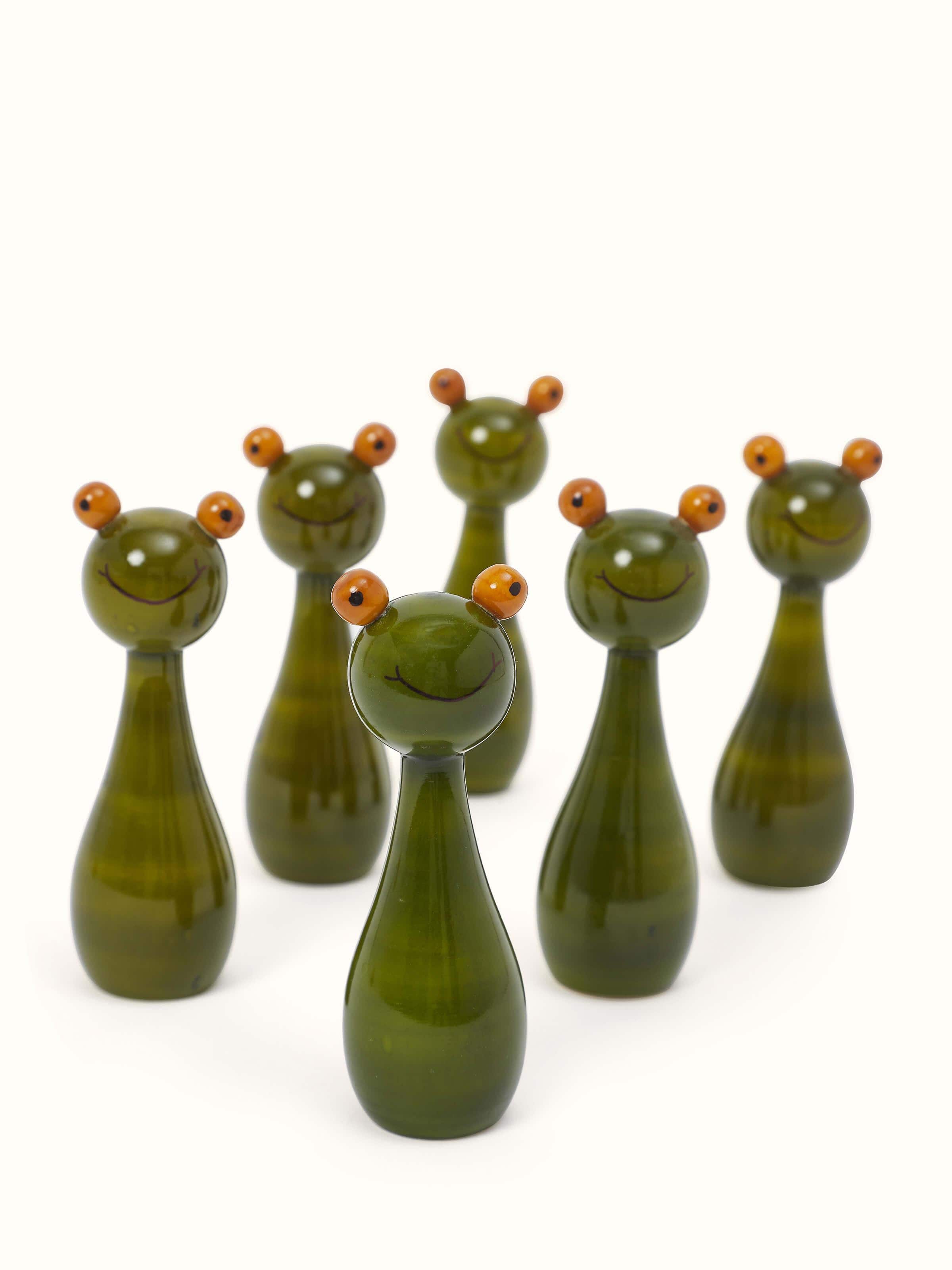 Front view of Channapatna Turnery 8-Piece Snow Ball Game in green, showing all pieces and their smooth finish