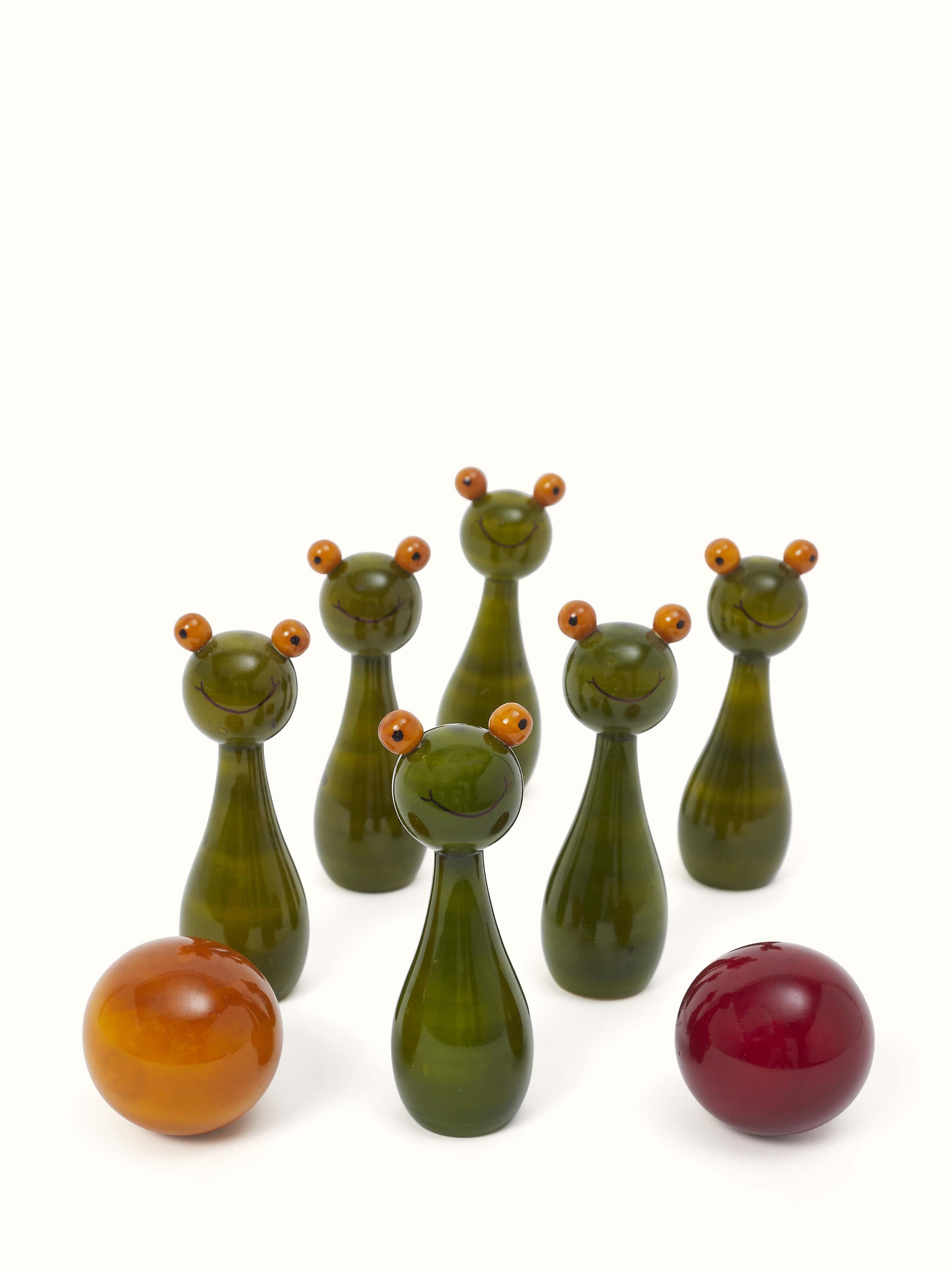 Angled view of Channapatna Turnery 8-Piece Snow Ball Game in green, highlighting the craftsmanship and design