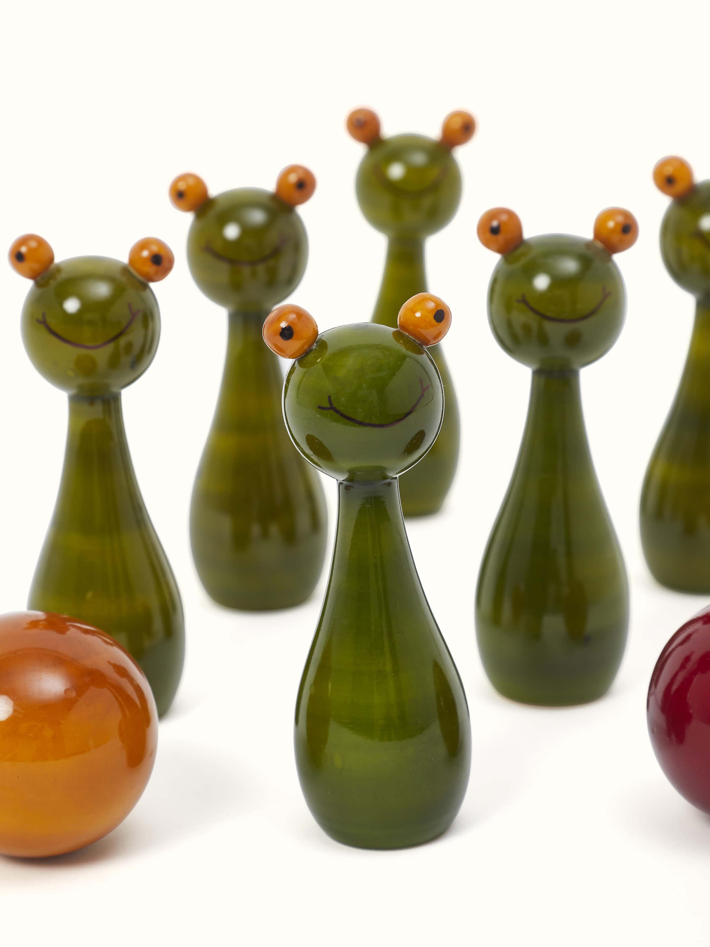 Close-up view of Channapatna Turnery 8-Piece Snow Ball Game in green, emphasizing the detailed turning work