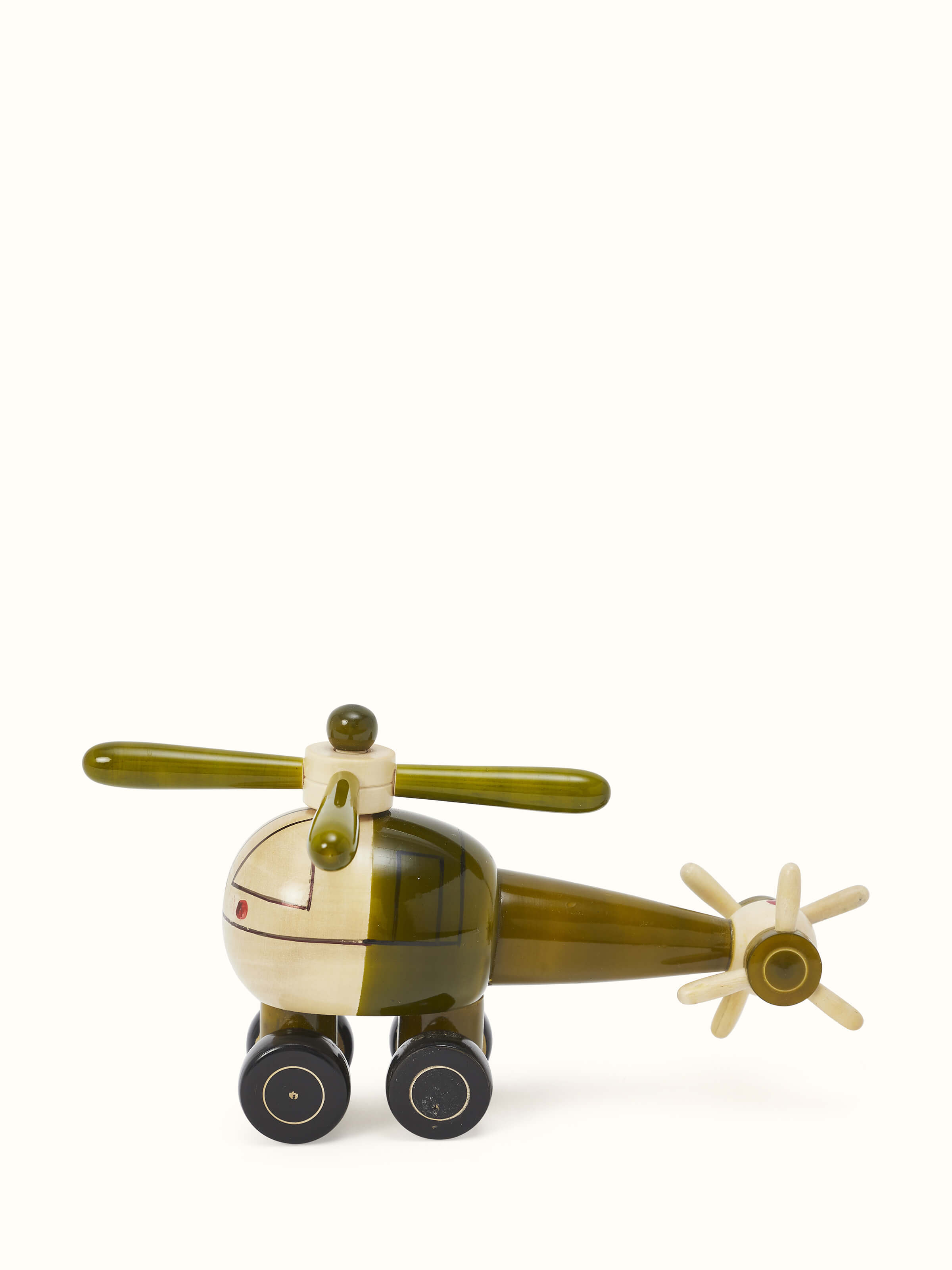 Artistic view of Channapatna ivory wood helicopter toy in green, showcasing the overall design.