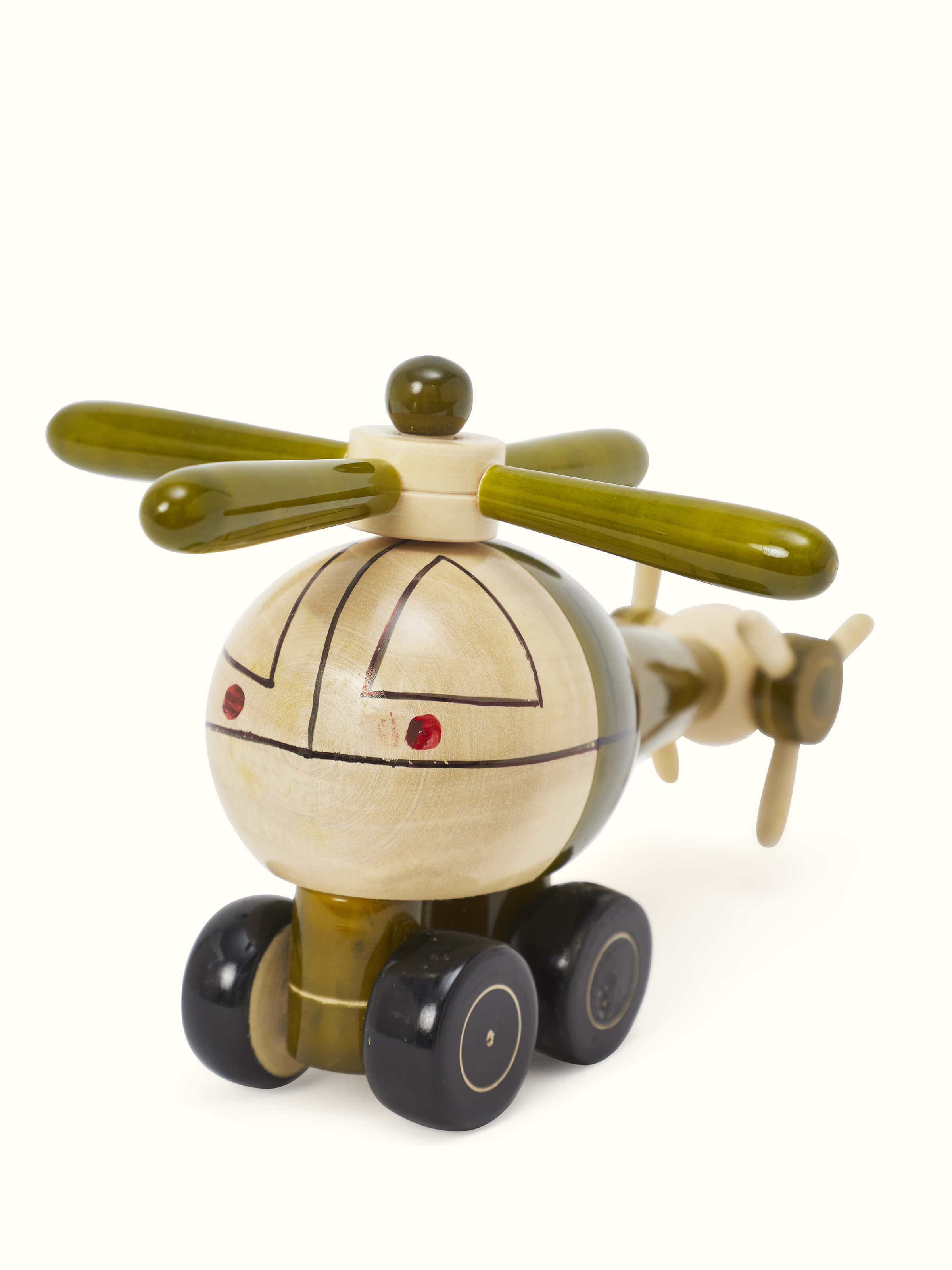 Detailed view of Channapatna ivory wood helicopter toy in green, focusing on the craftsmanship.