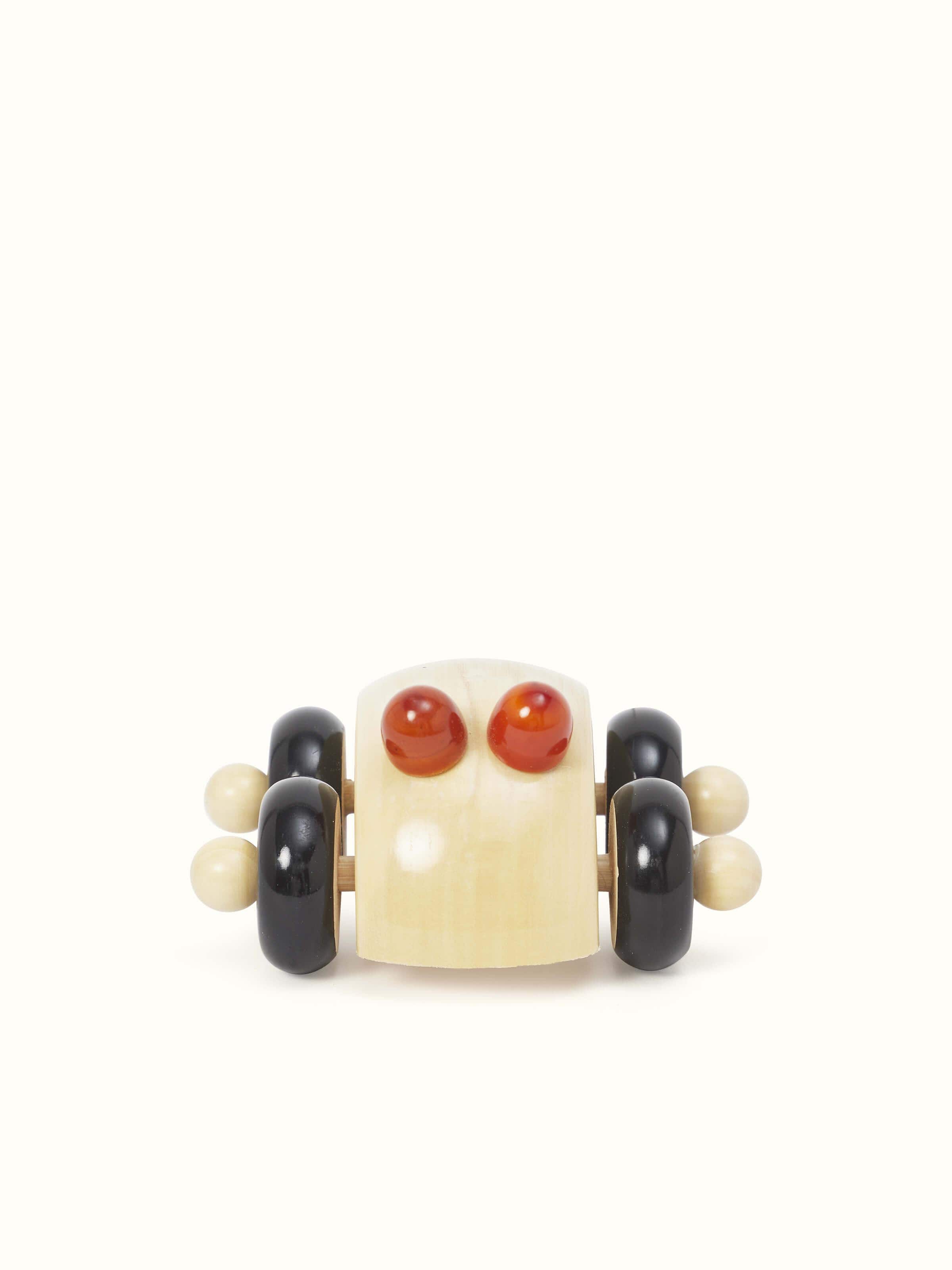 Front view of Channapatna ivory wood round car toy in off-white color highlighting the smooth wood finish and round design.