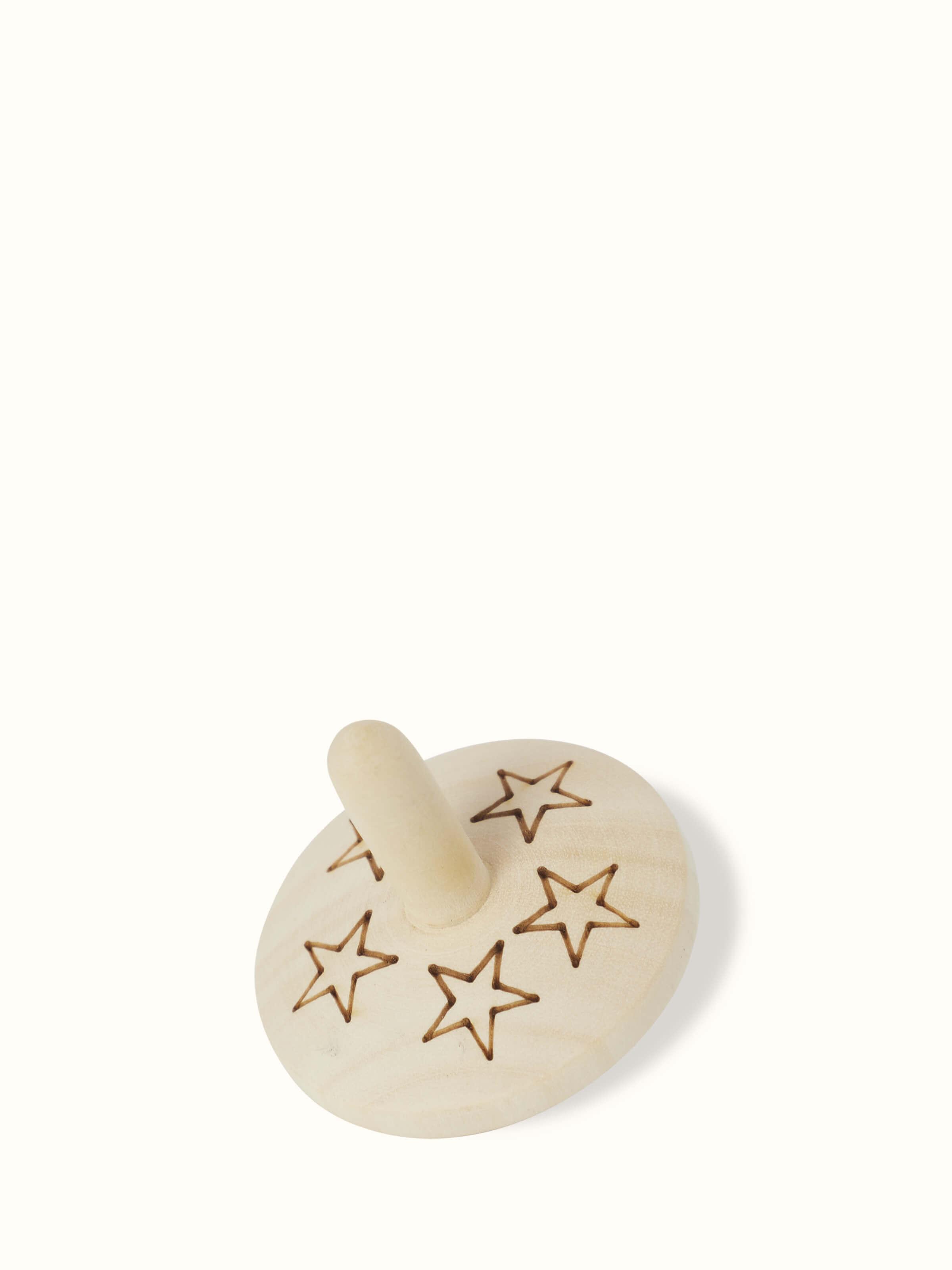 Close-up of Channapatna Ivory Wood Spinning Top Toys in Off-White showcasing smooth finish.