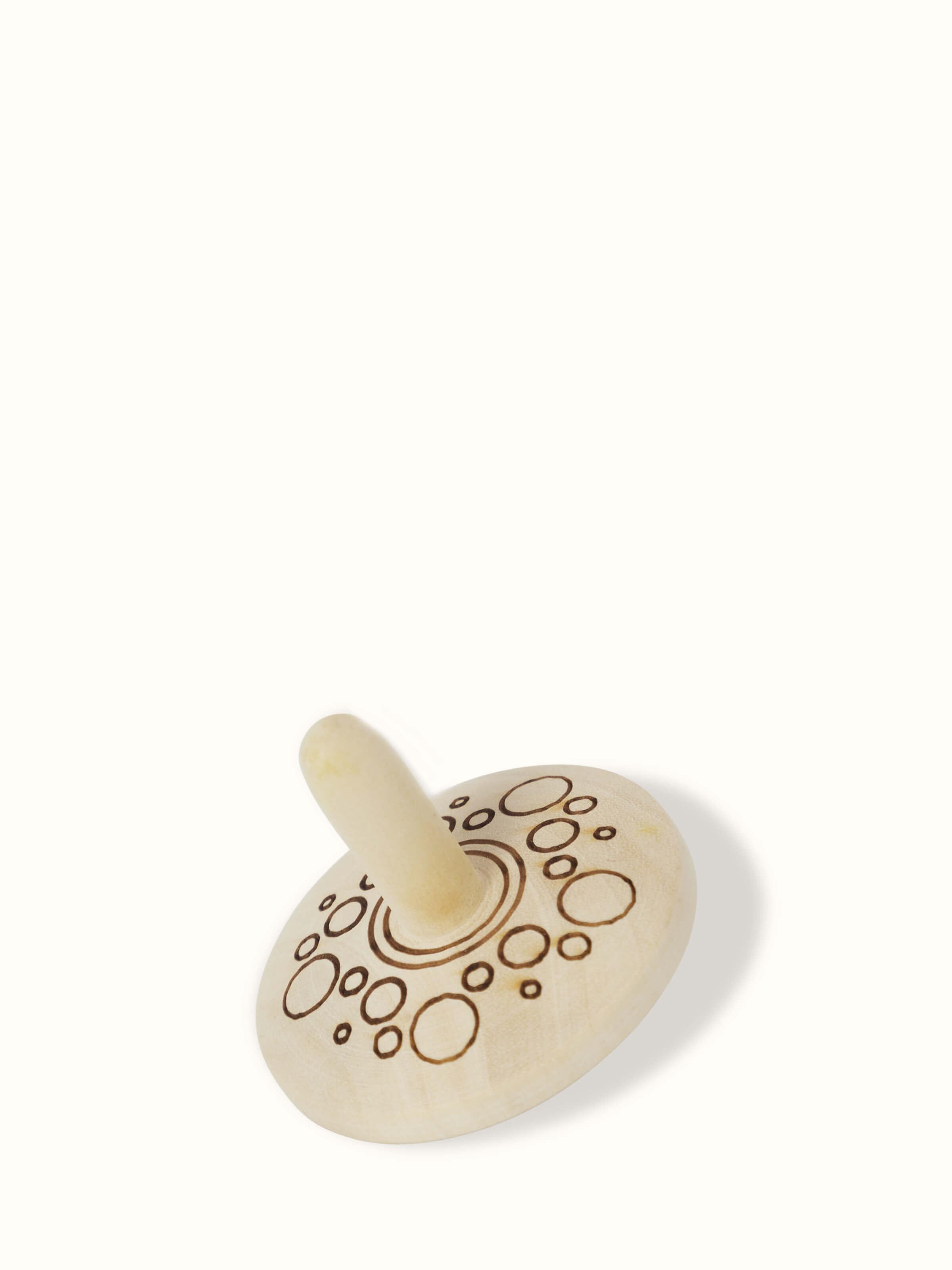 Detailed view of Channapatna Ivory Wood Spinning Top Toys in Off-White highlighting their traditional style.