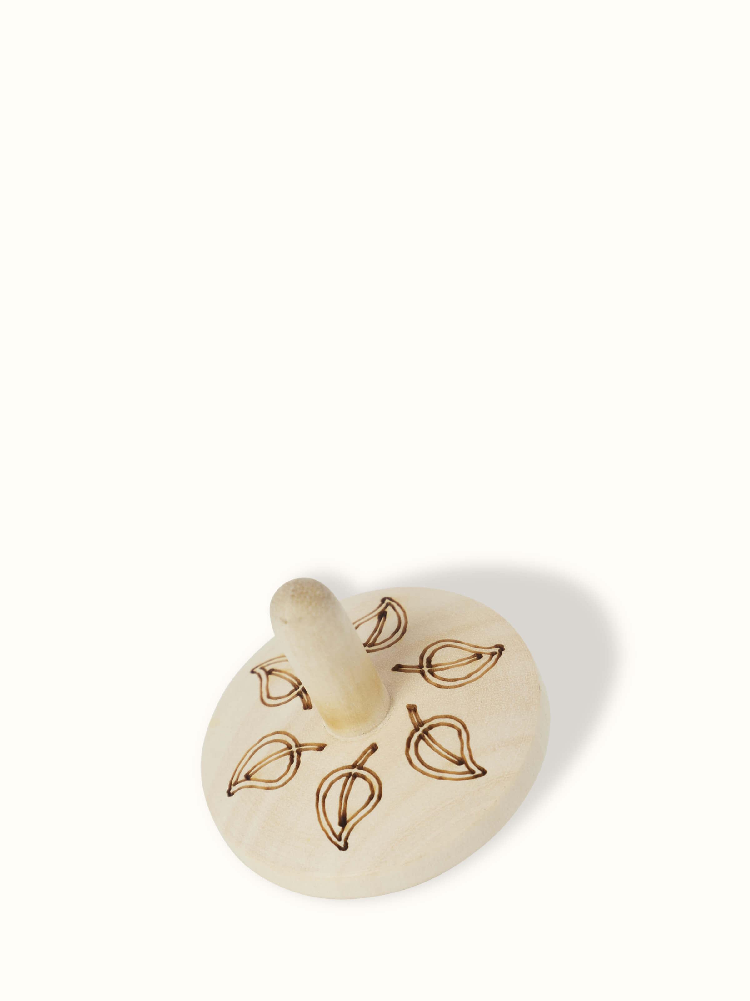 Front view of Channapatna Ivory Wood Spinning Top Toys in Off-White showing the set arrangement.