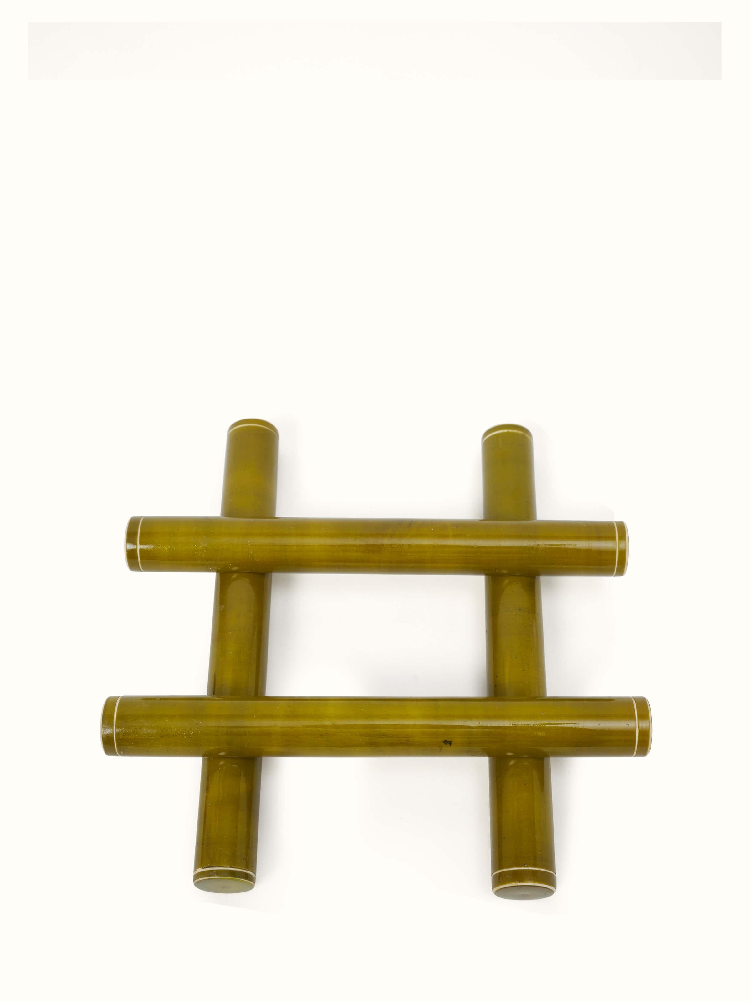 Side view of Channapatna ivory wood tic-tac game in green focusing on wooden finish.