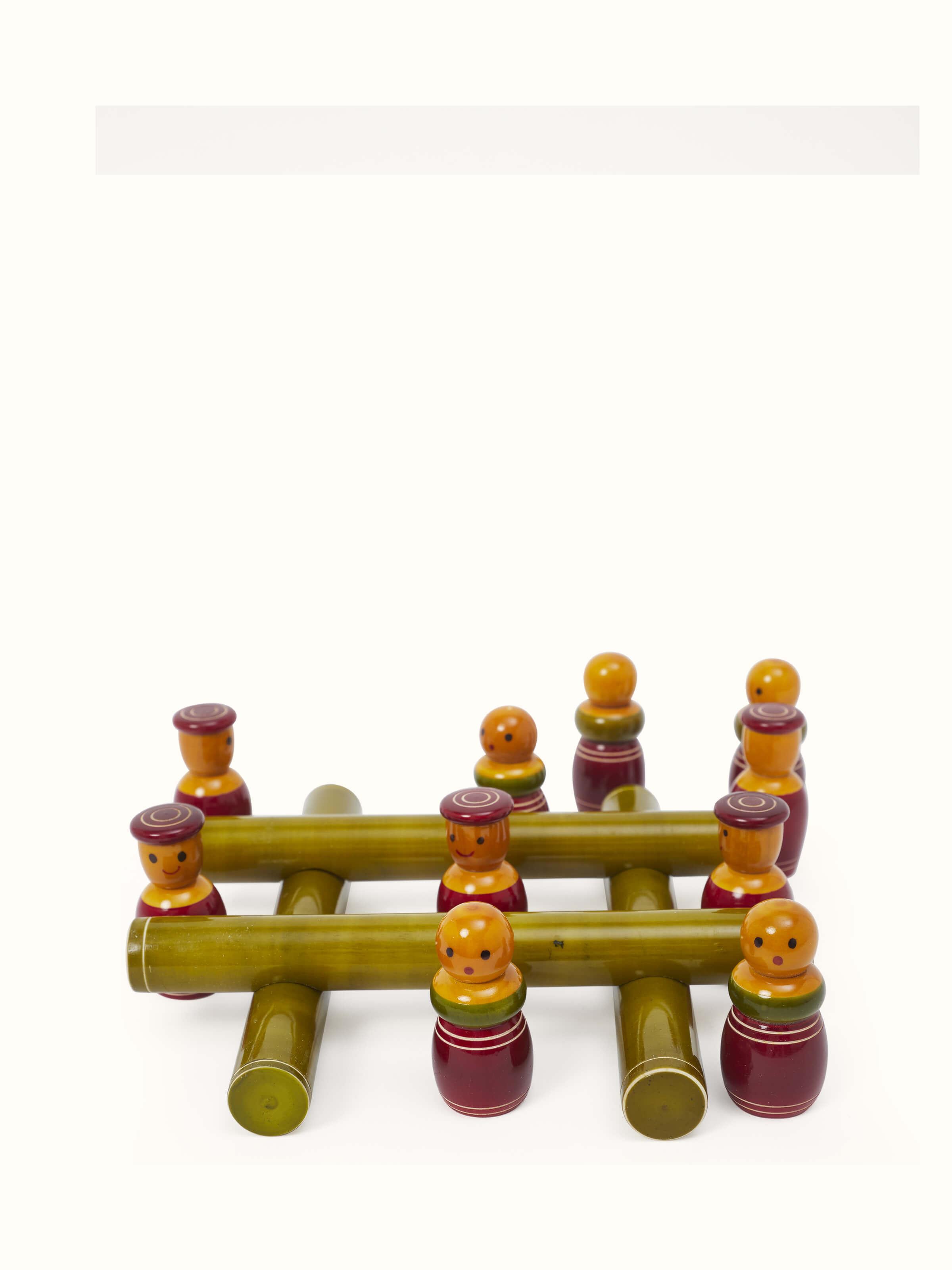 Detailed view of Channapatna ivory wood tic-tac game in green emphasizing craftsmanship.