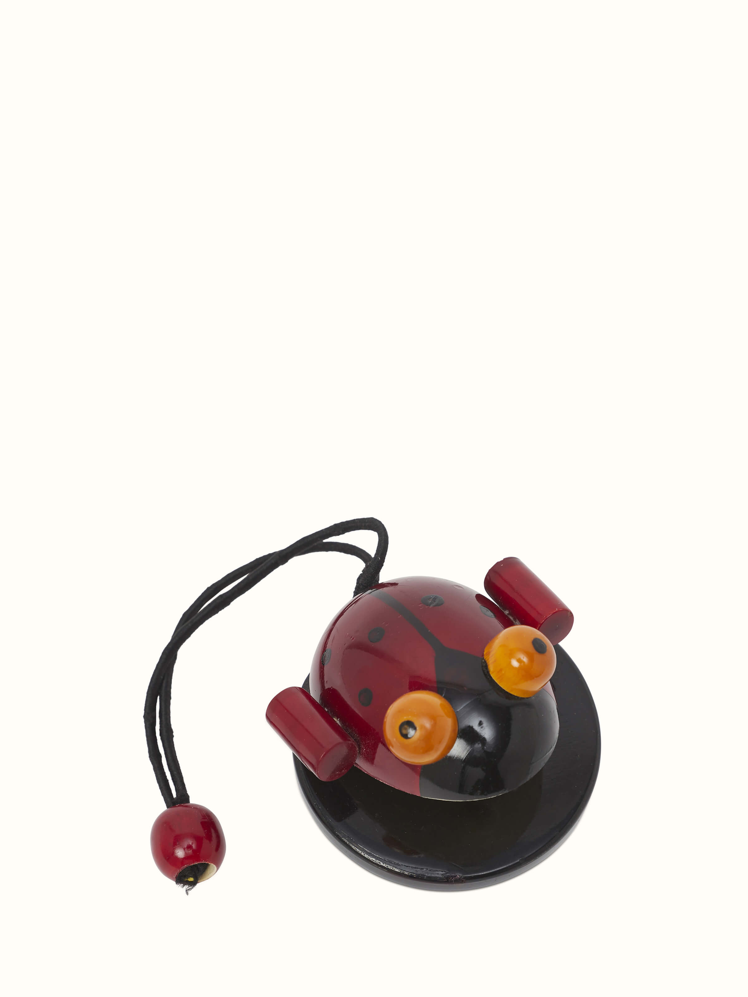 Side angle of Channapatna wooden noisy bug toy showing its unique design and wooden texture