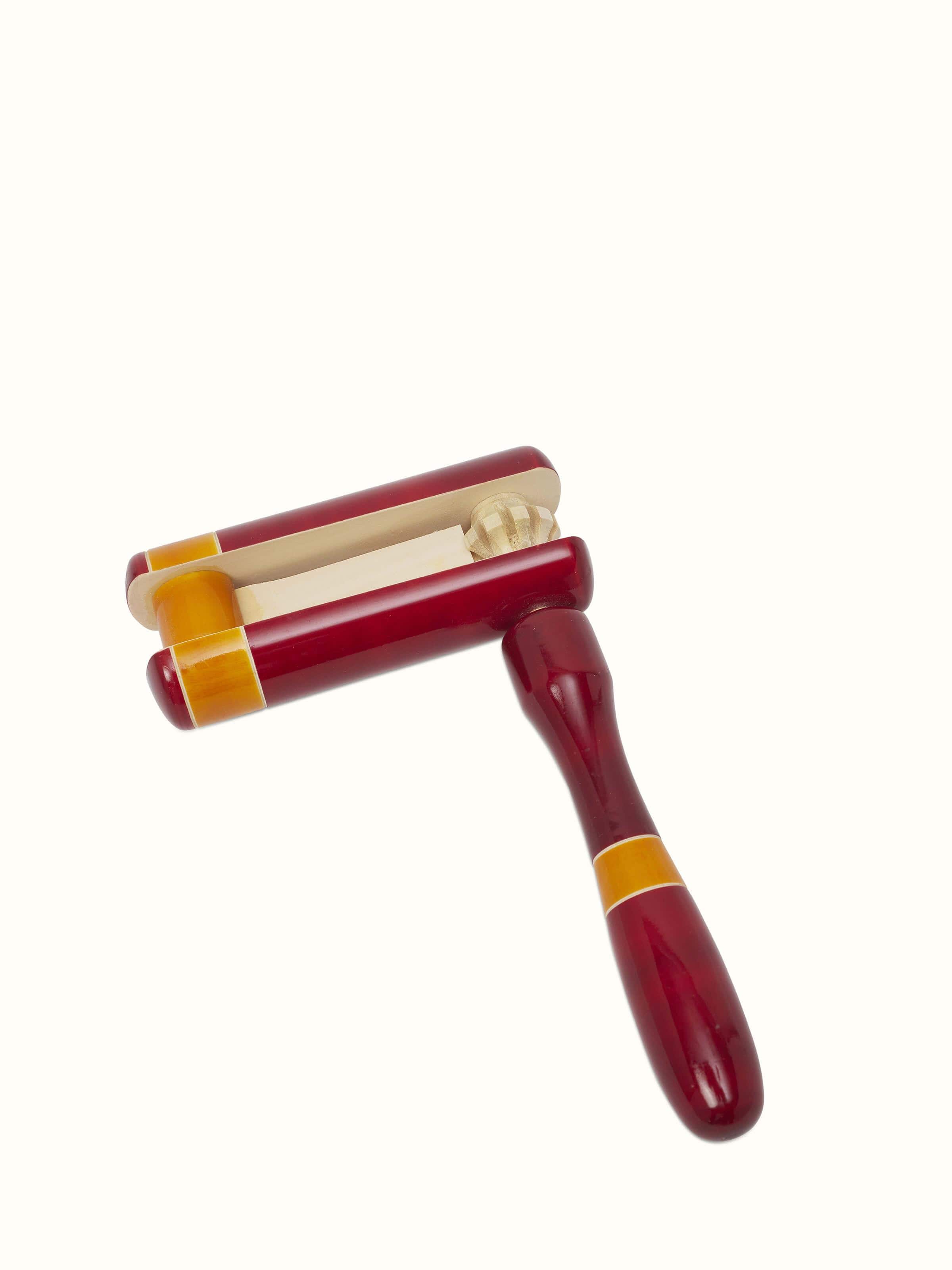 Side view of Channapatna Wooden Tic-Tic Toy, highlighting the toy's shape and construction