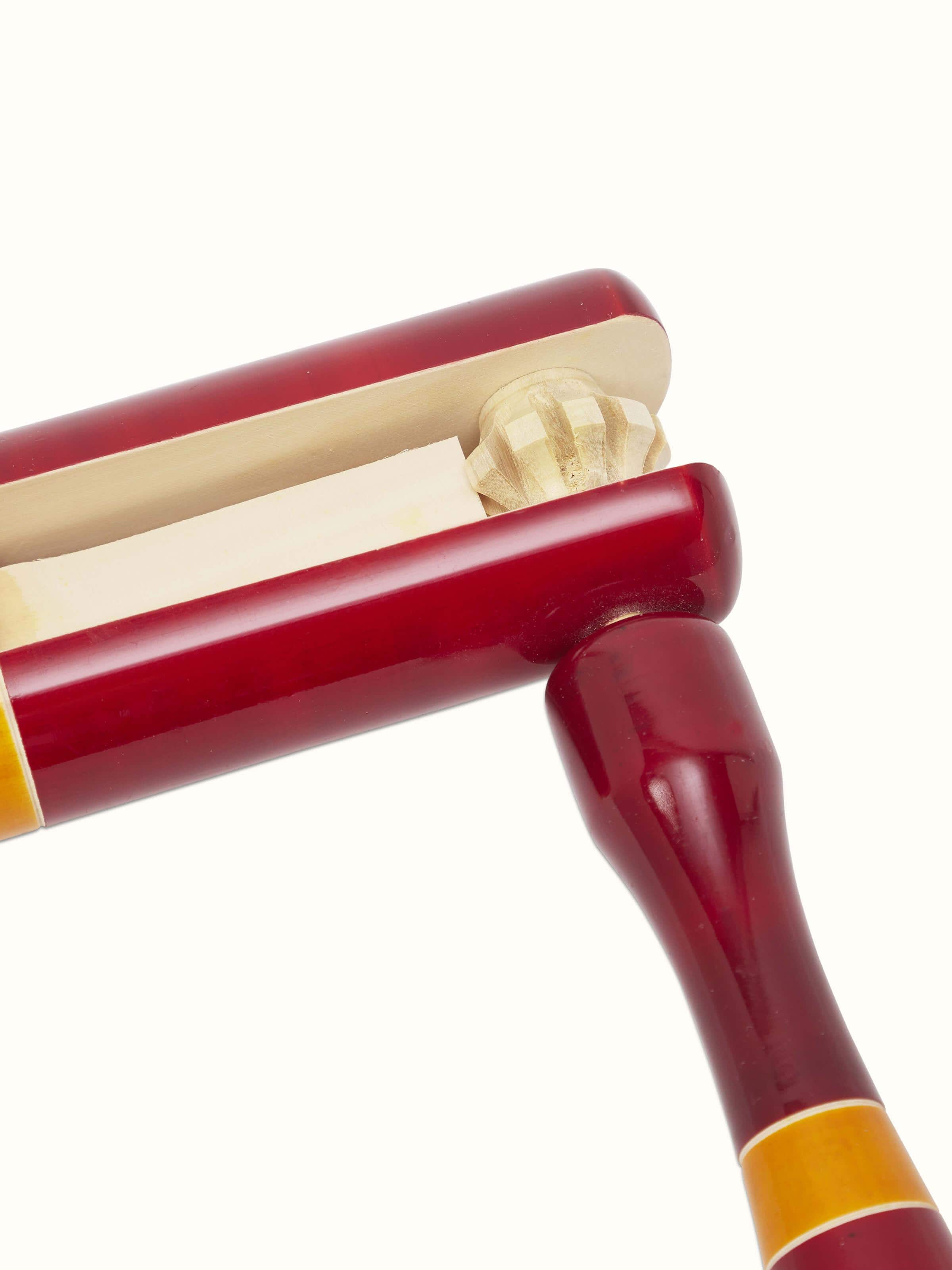 Angled view of Channapatna Wooden Tic-Tic Toy, showing the detailed craftsmanship and paintwork