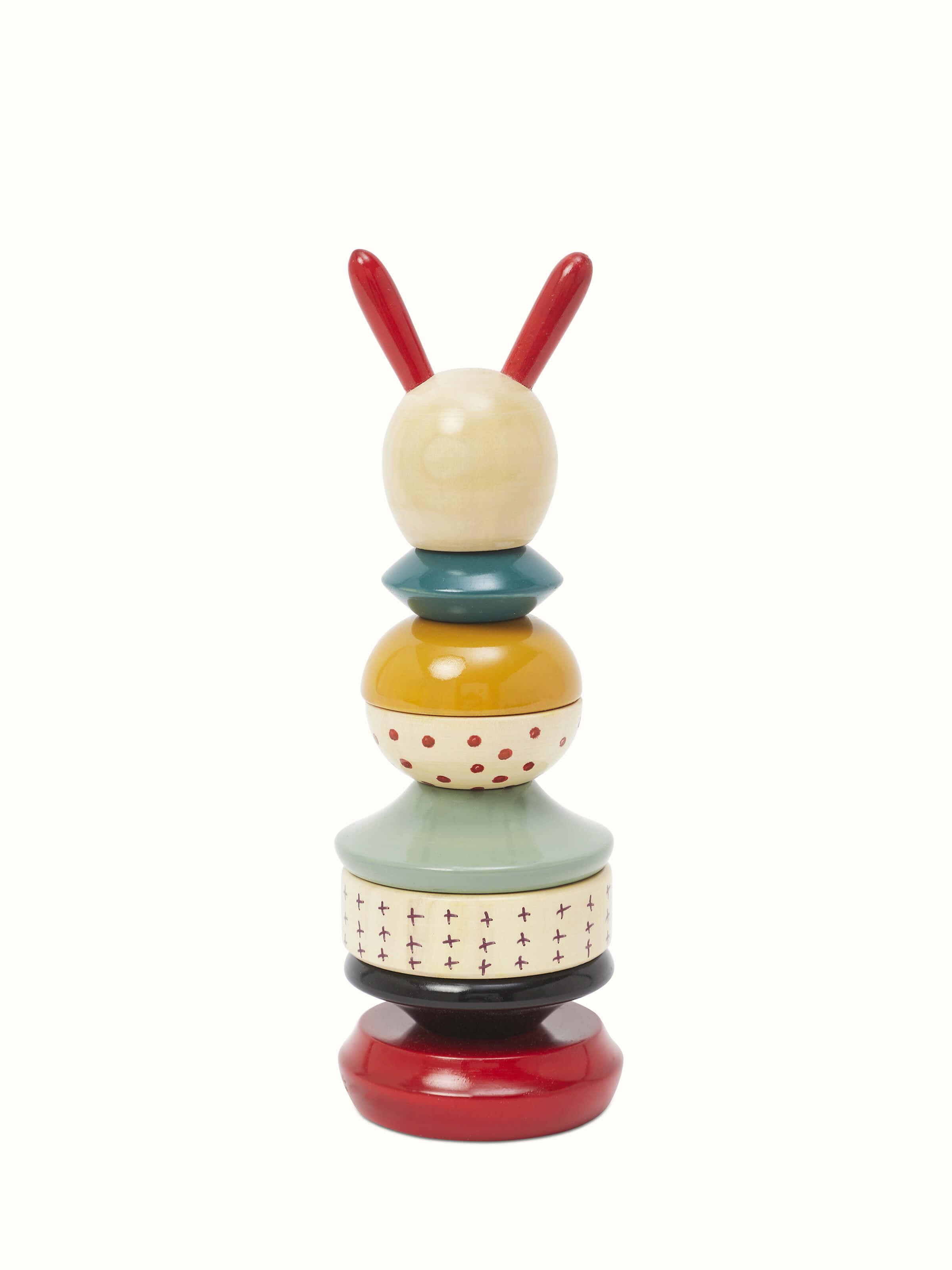 Side view of Channapatna ivory wood long rabbit stacking toy in white, showcasing its handcrafted features