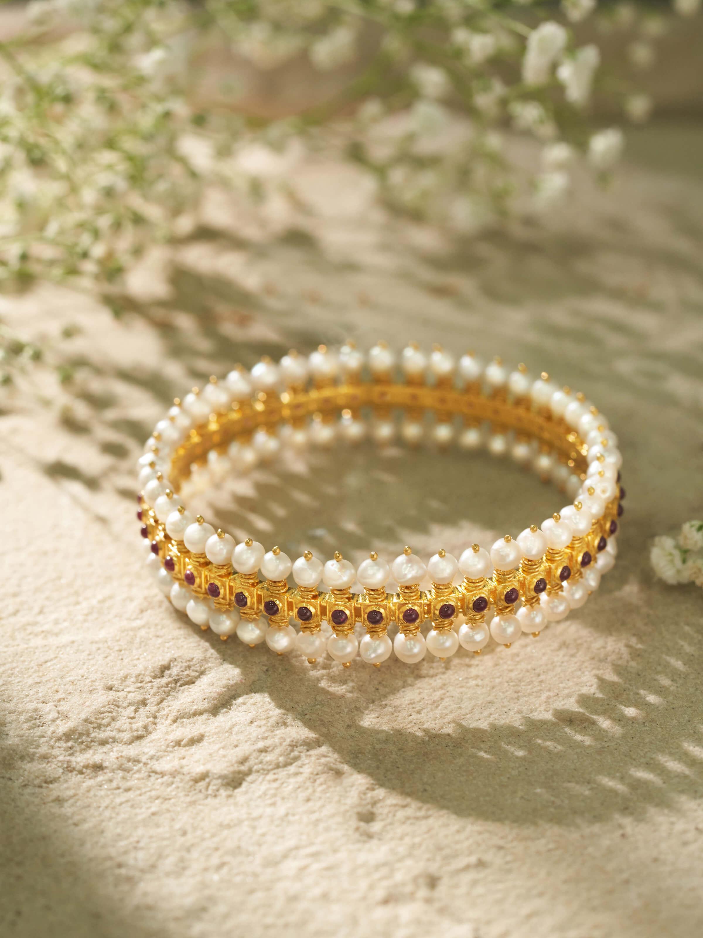 Angled view of Guttapusalu silver bangle showcasing its elegant form and intricate craftsmanship