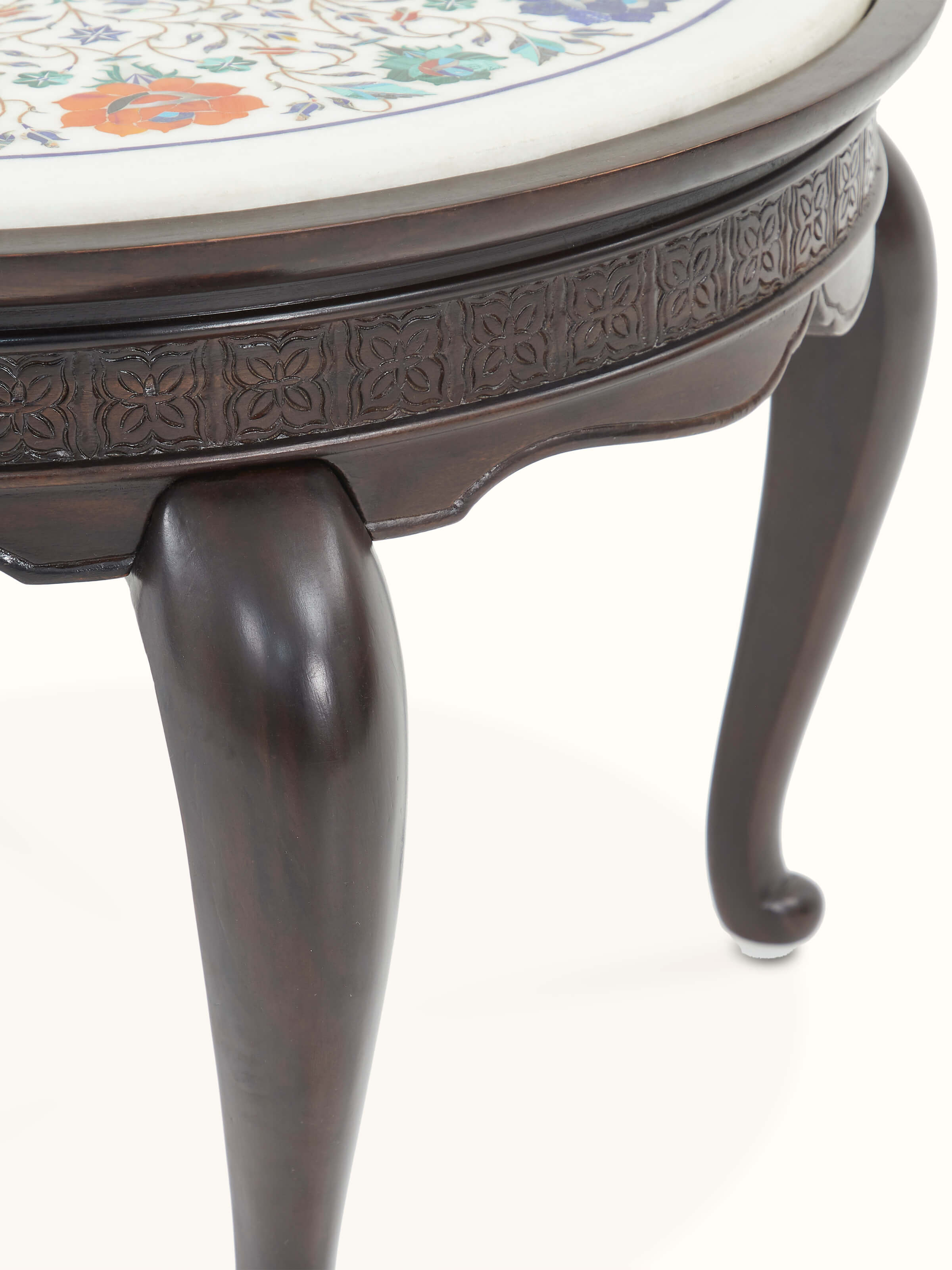 Artistic view of the round marble inlaid Sheesham wood coffee table, focusing on the marble inlay and wooden structure