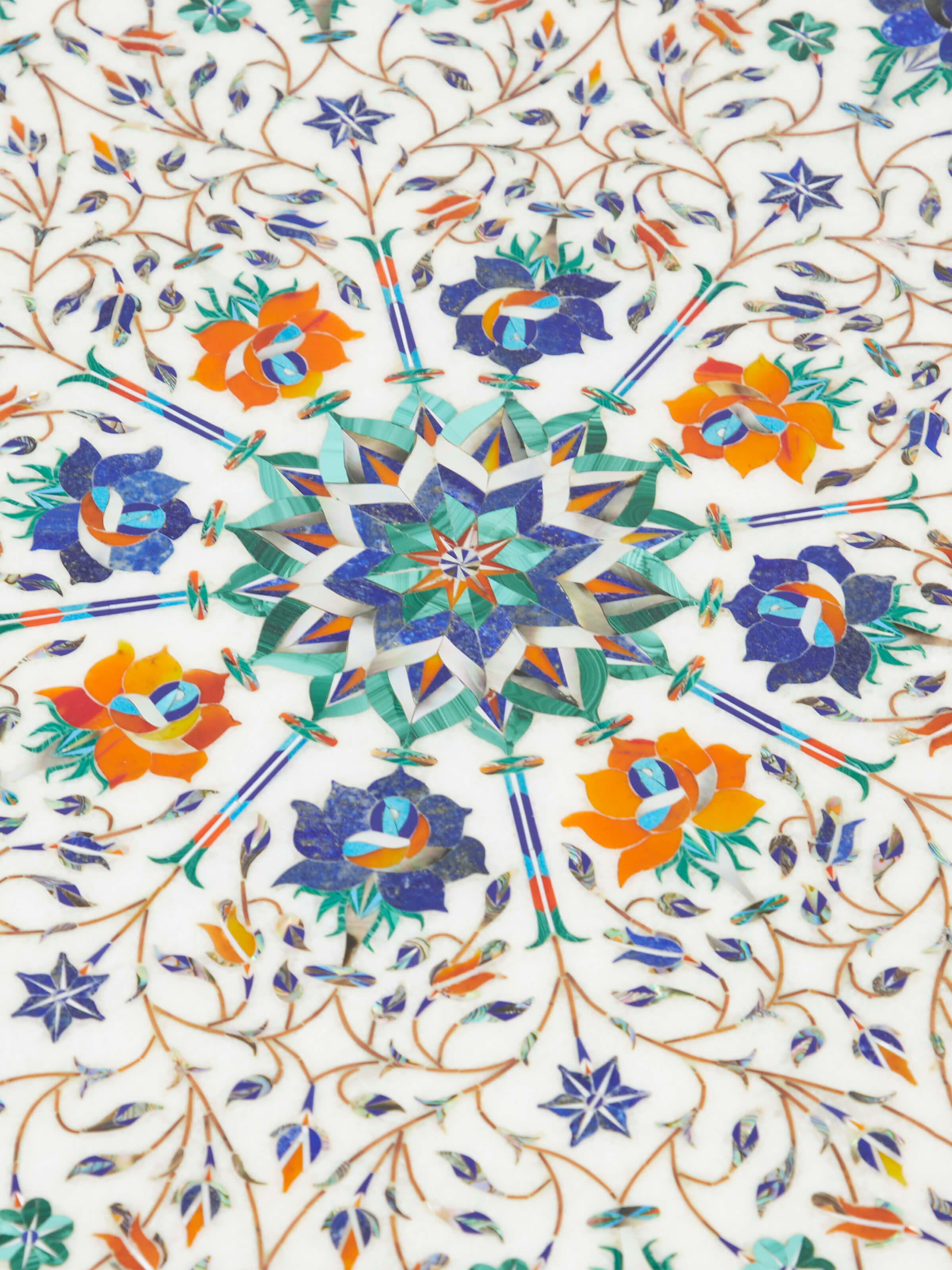 Angle view of the round marble inlaid Sheesham wood coffee table, capturing the overall design and marble top