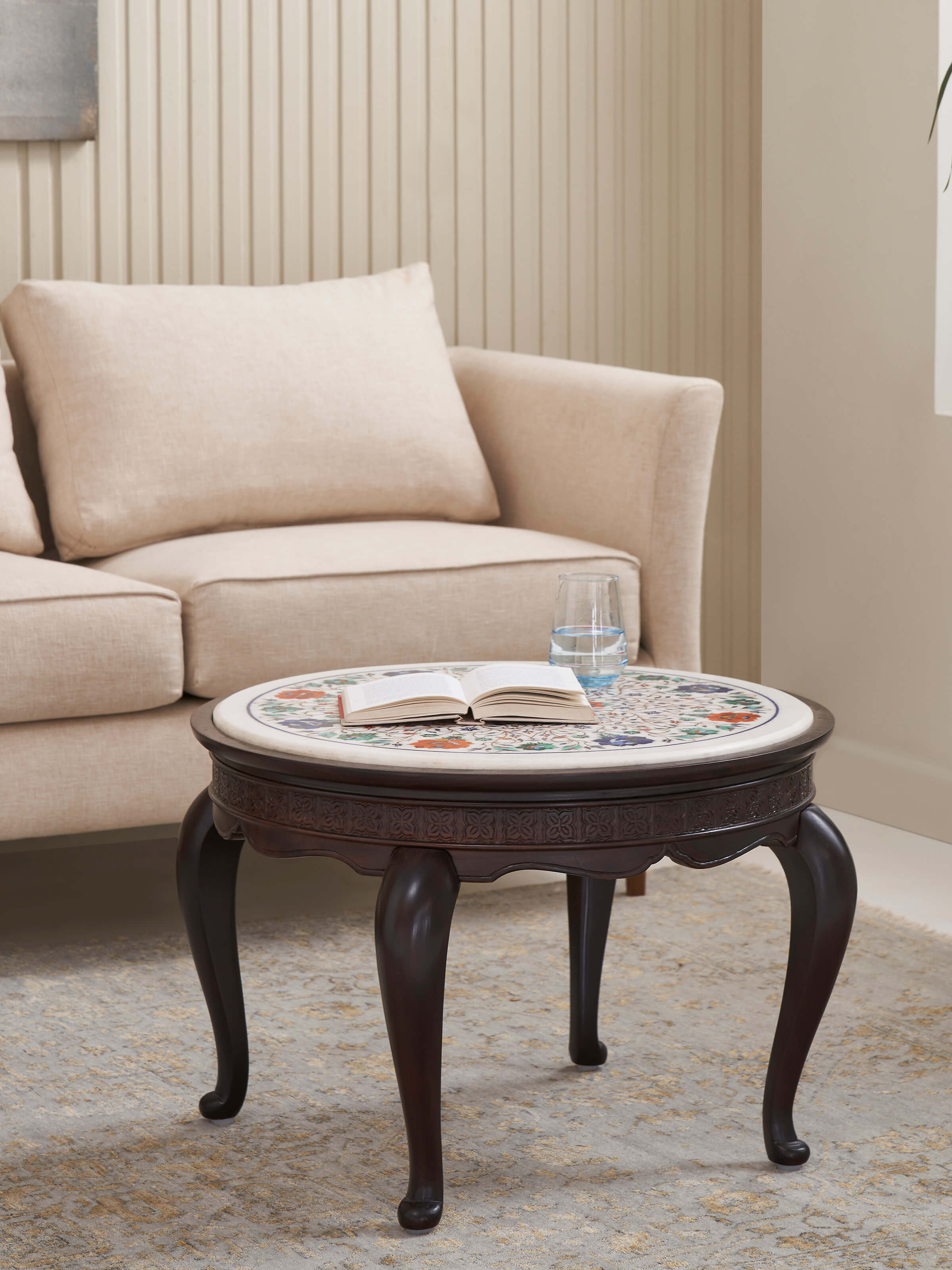 Side view of the round marble inlaid Sheesham wood coffee table, highlighting the sleek wooden legs and marble top