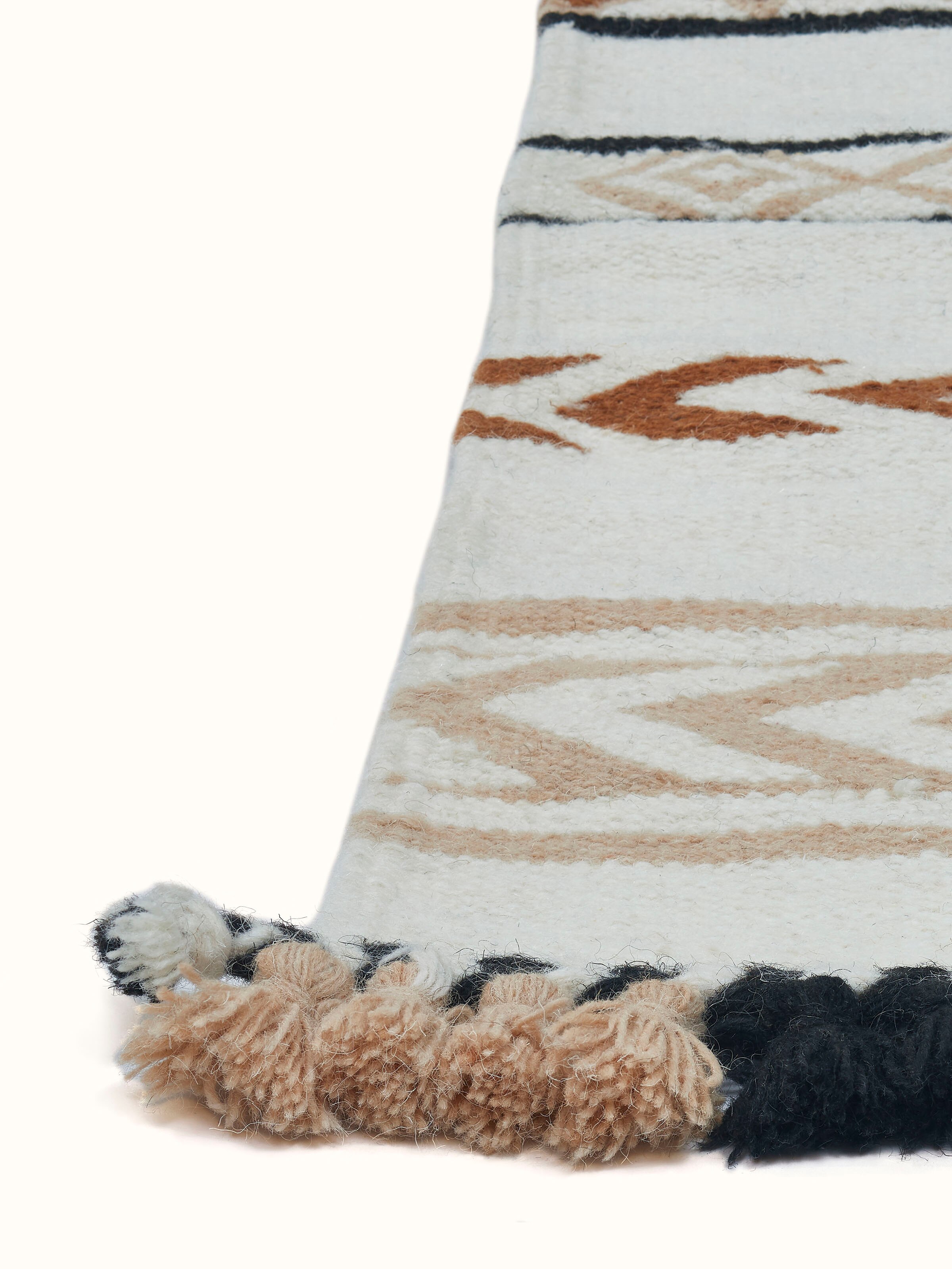 Angled view of Geo stripes ivory Gujarat wool & cotton panja dhurrie kharad, displaying the full geometric stripe pattern and craftsmanship