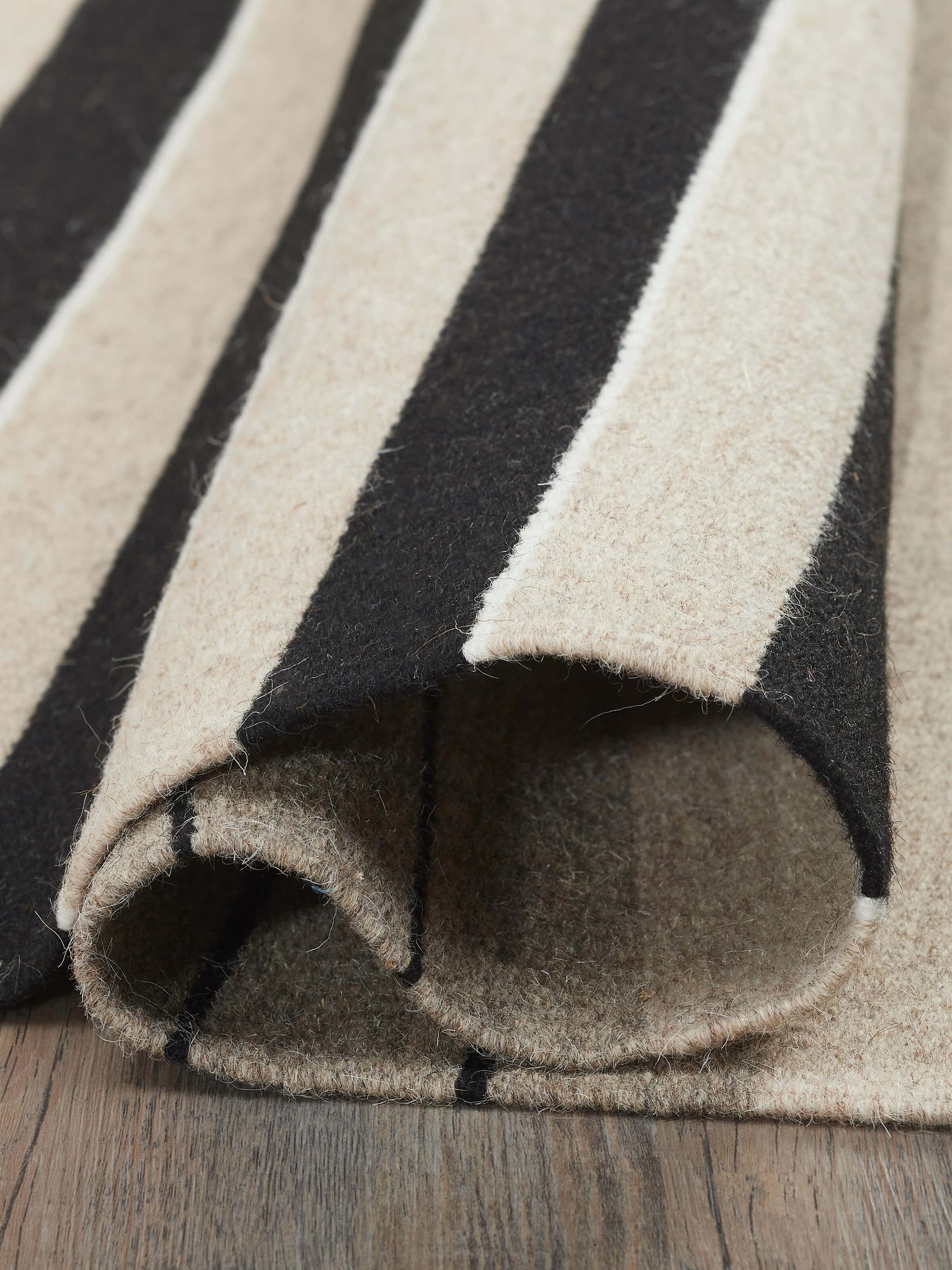 Full view of Nomad Stripes Black Beige Jawaja Wool & Cotton Handloom Dhurrie (4x6 ft) displaying entire design