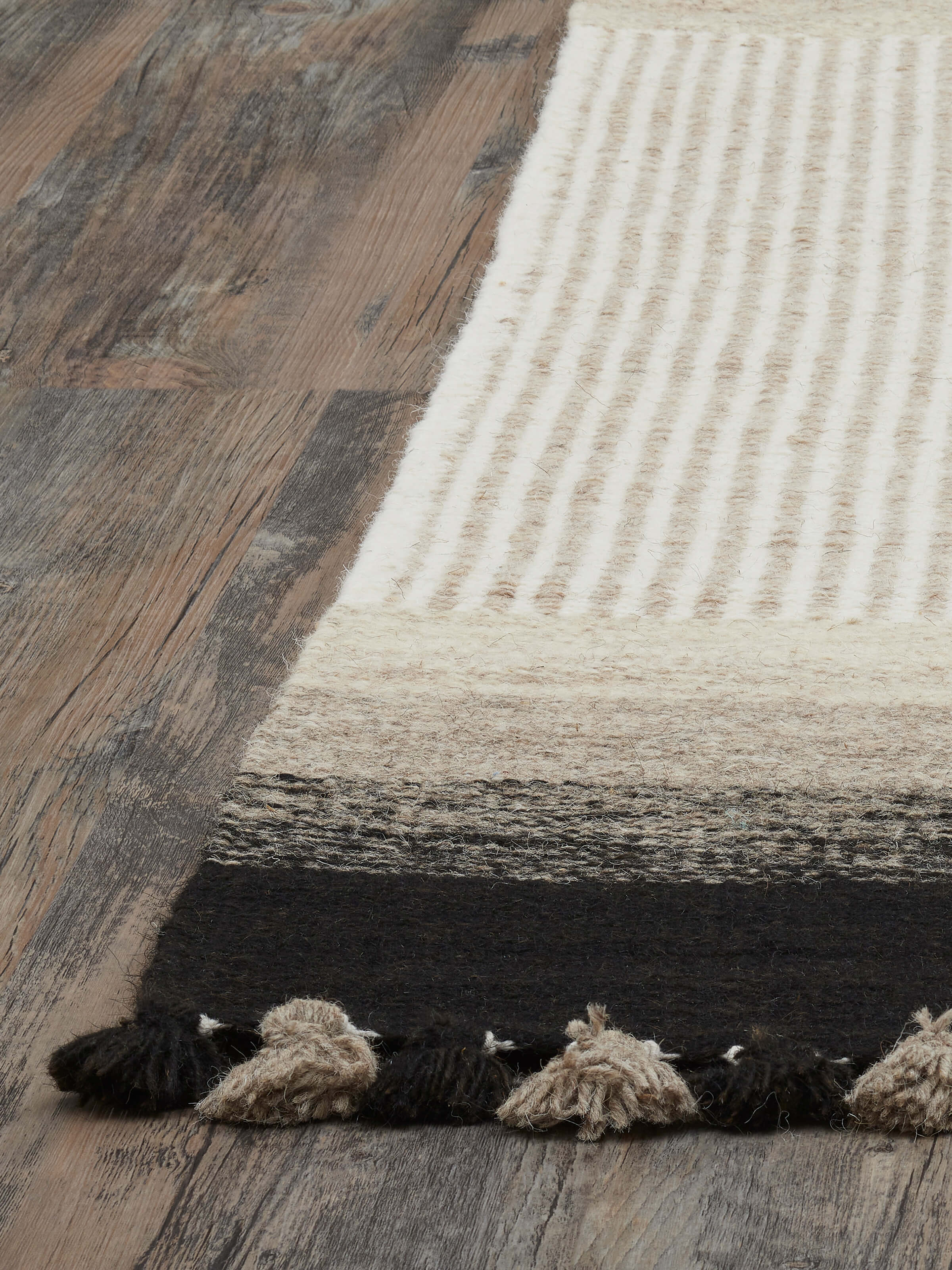 Detailed view of Textured Stripes Beige Black Jawaja Wool & Cotton Handloom Dhurrie, focusing on the intricate weaving and color contrast.