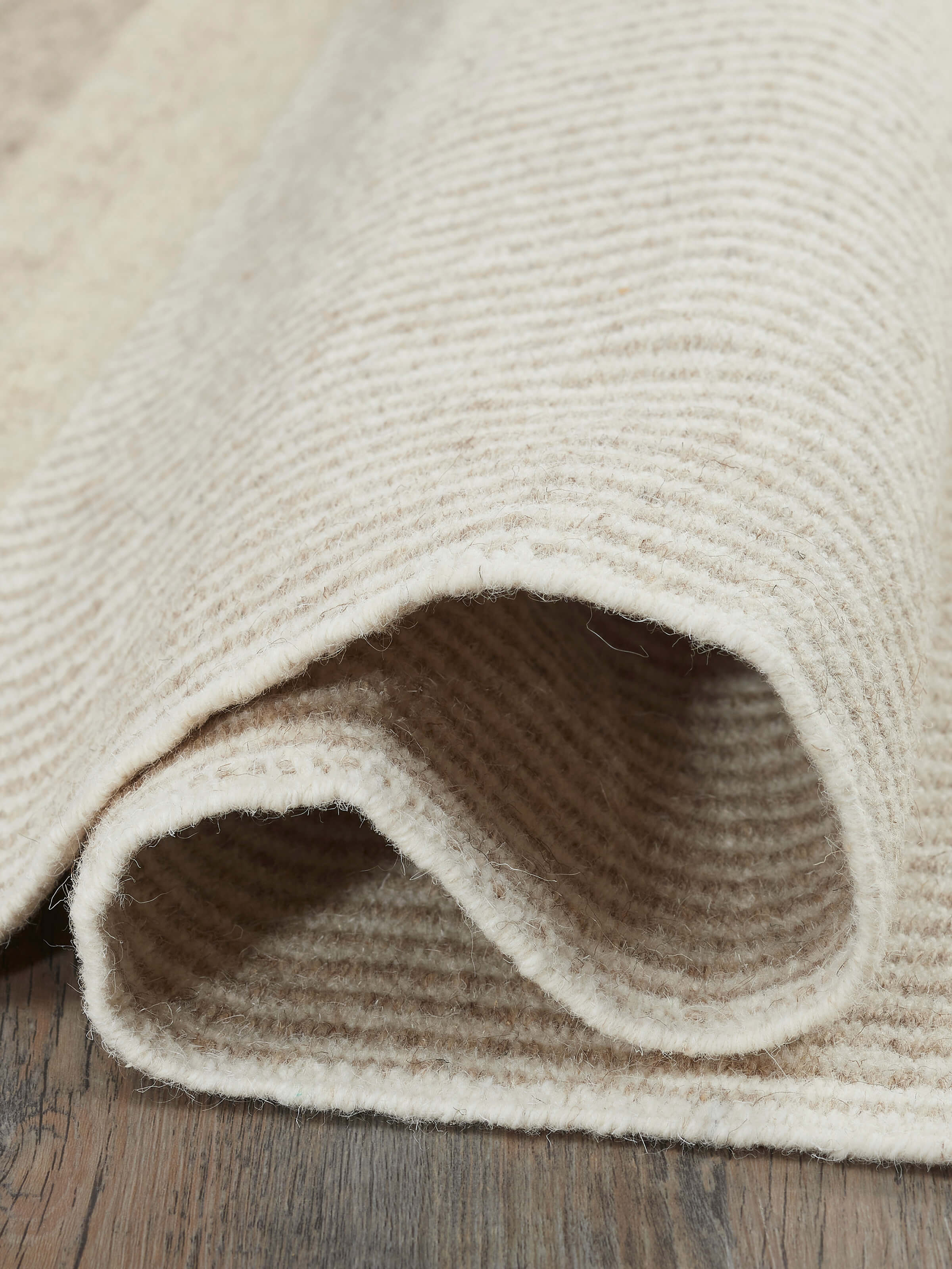 Close-up of Textured Stripes Beige Black Jawaja Wool & Cotton Handloom Dhurrie, highlighting the rich texture and striped pattern.