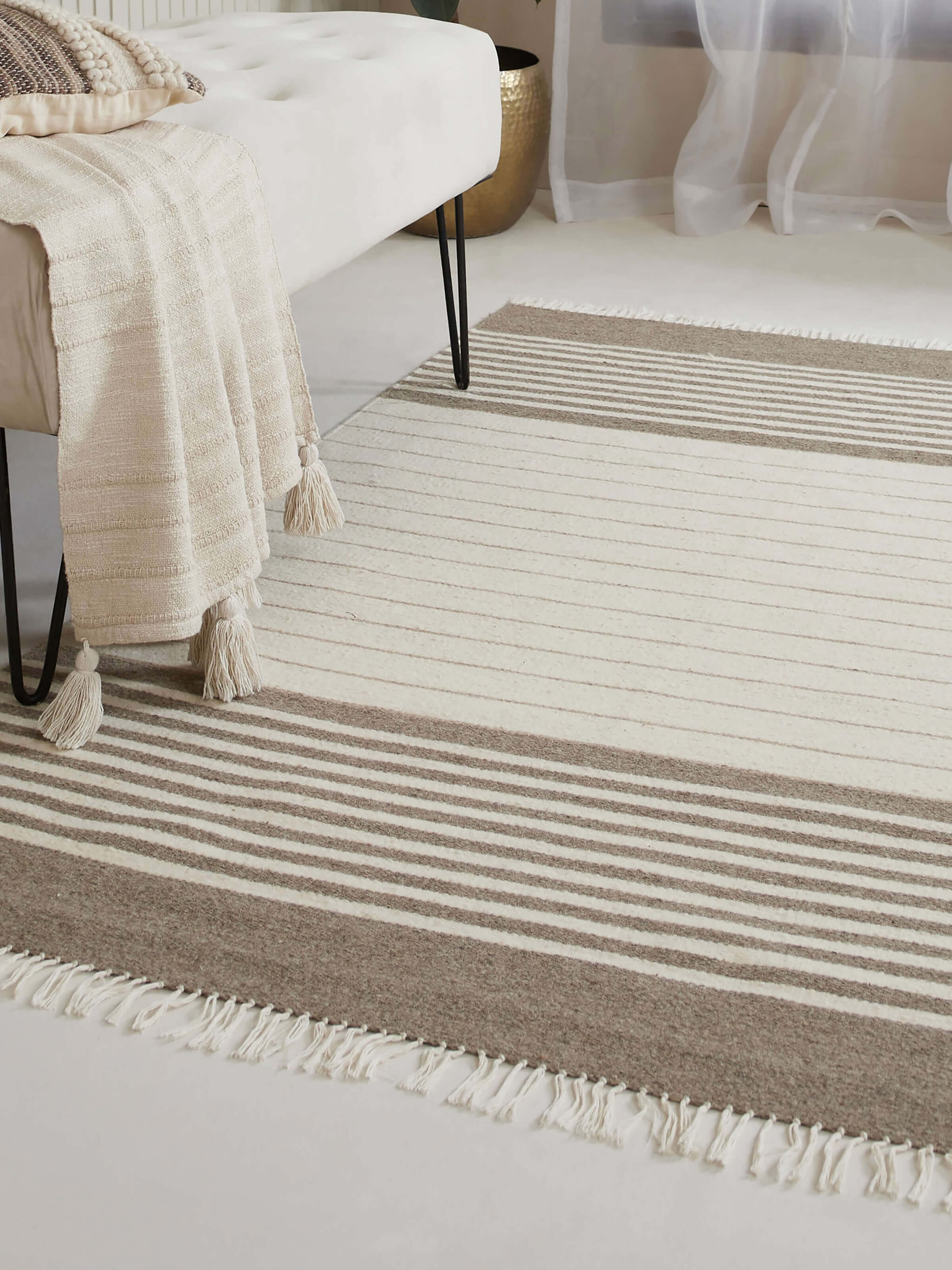 Room setting featuring beige and ivory striped Jawaja wool handloom dhurrie in 4x6 ft size.