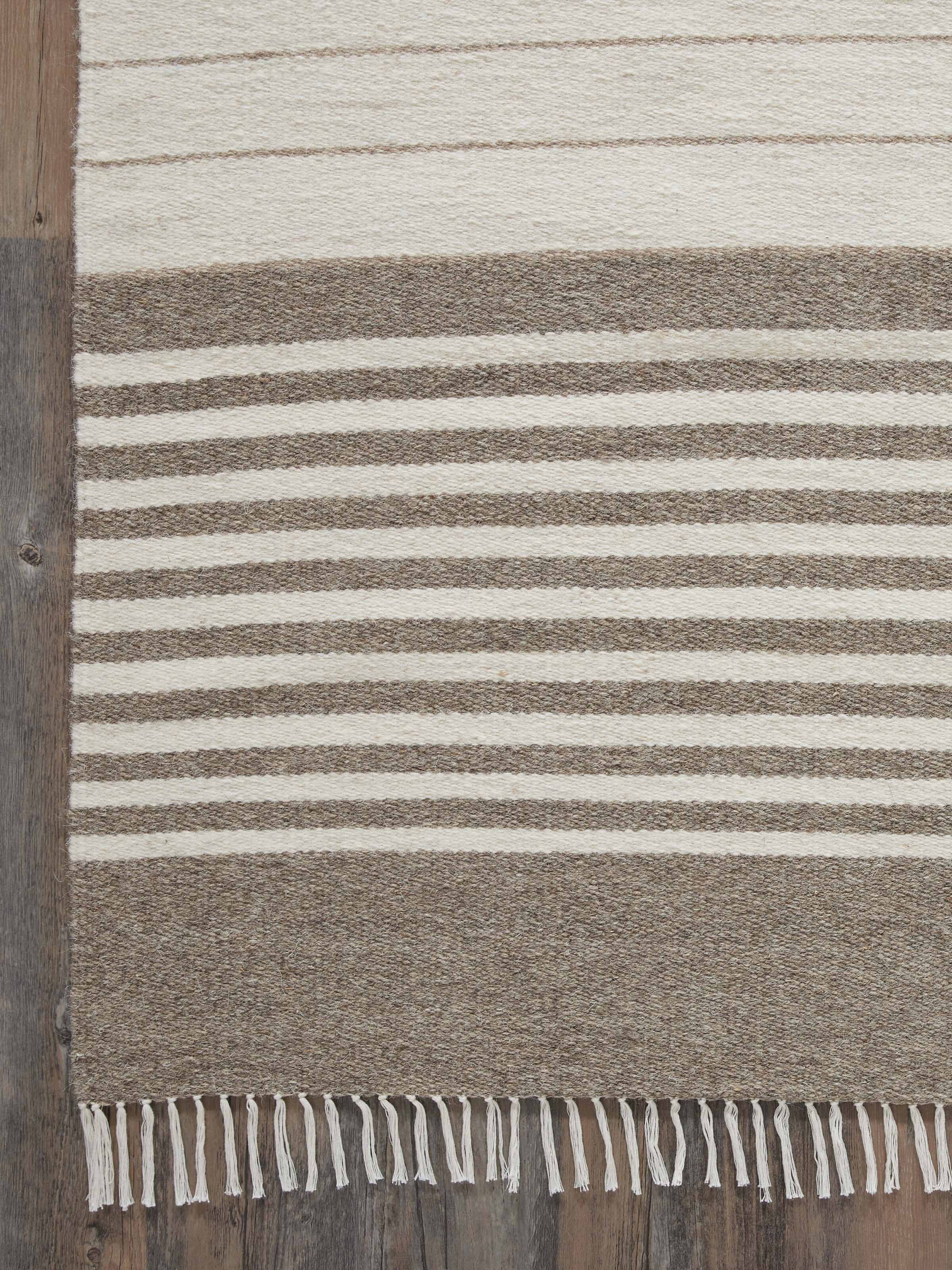 Nomad stripes beige ivory Jawaja dhurrie folded, showing the design from a different angle