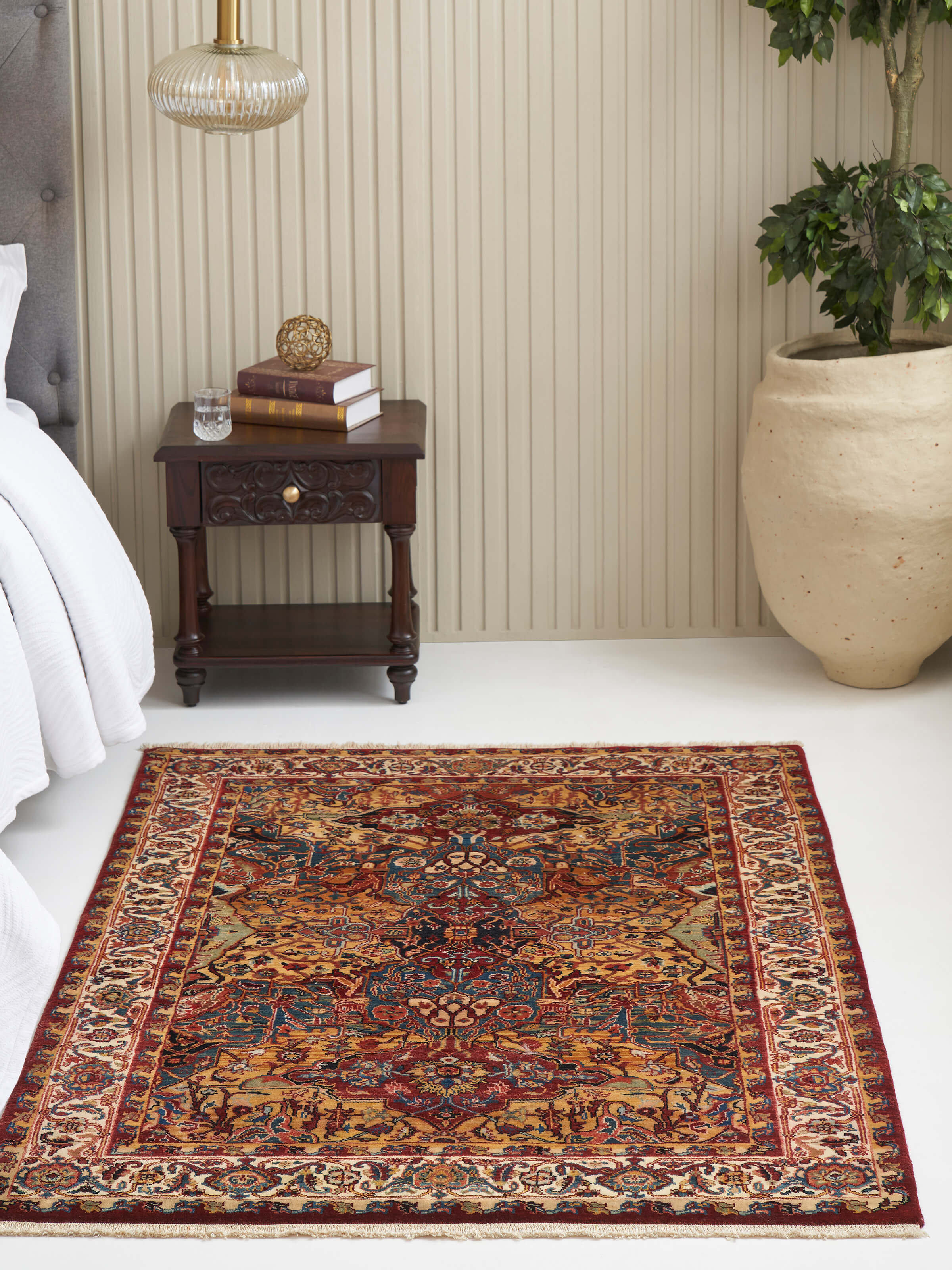 Room view showcasing Heriz-style hand-knotted wool rug in Jaipur red with traditional Persian motifs.