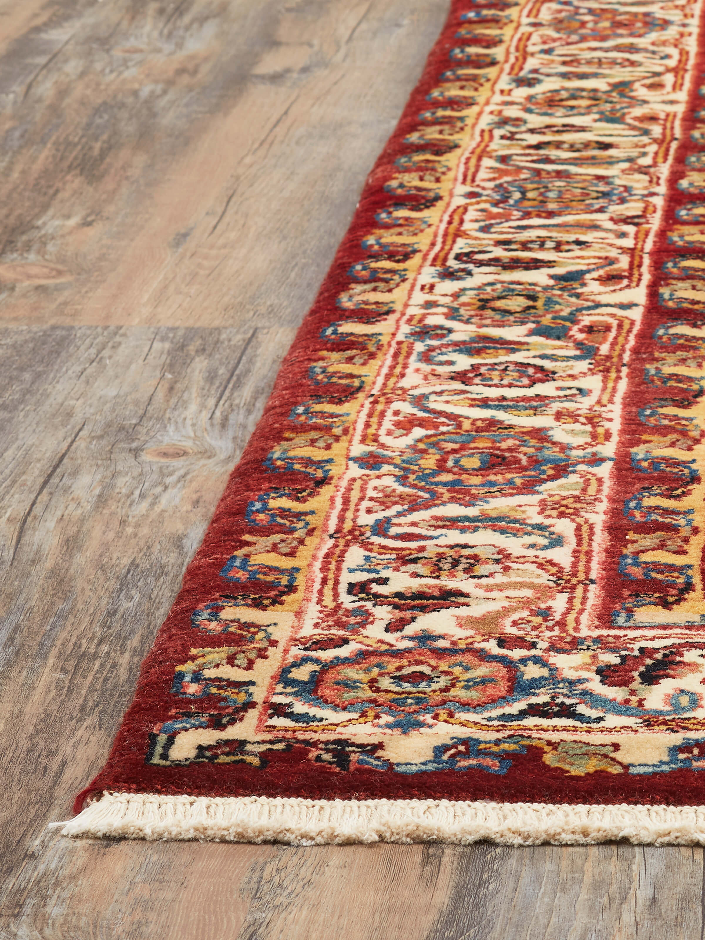 Angled view of Traditional Heriz Rust Jaipur Wool Hand-Knotted Rug displaying the intricate pattern and texture.