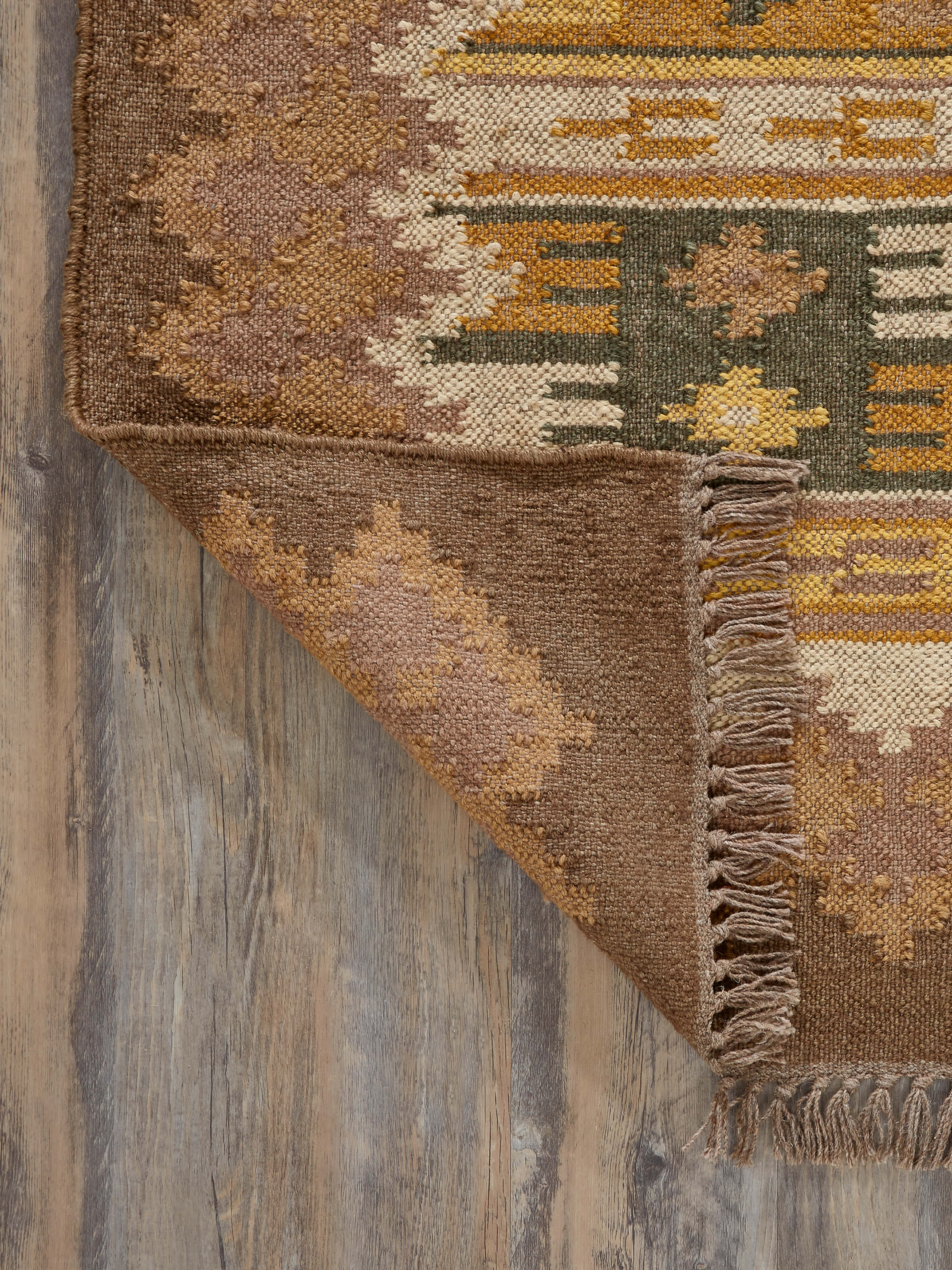 Back view of a traditional kilim brown jute & wool panja dhurrie, highlighting the craftsmanship and sturdy construction.