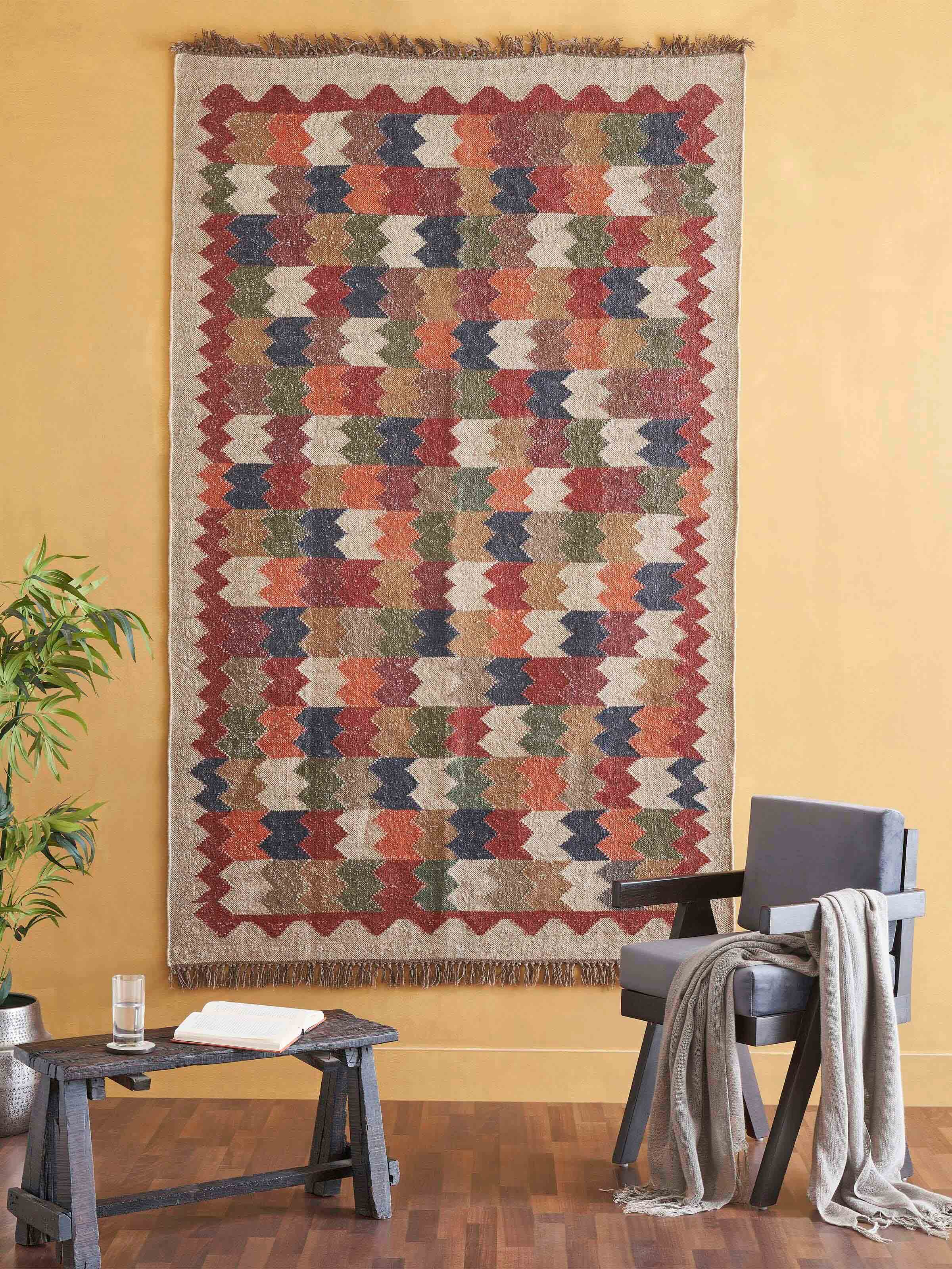 Close-up of Geo Chevrons Jute & Wool Panja Dhurrie, highlighting the intricate chevron pattern and the texture of the jute-wool fabric.