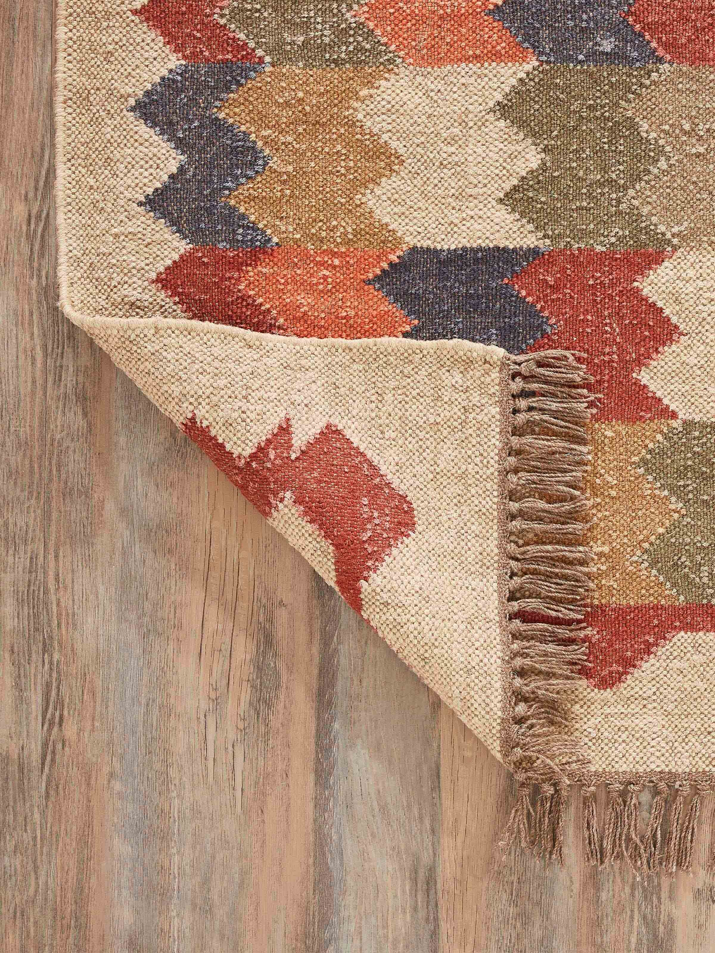 Full view of Geo Chevrons Jute & Wool Panja Dhurrie, showing the complete pattern and texture in a room setting.