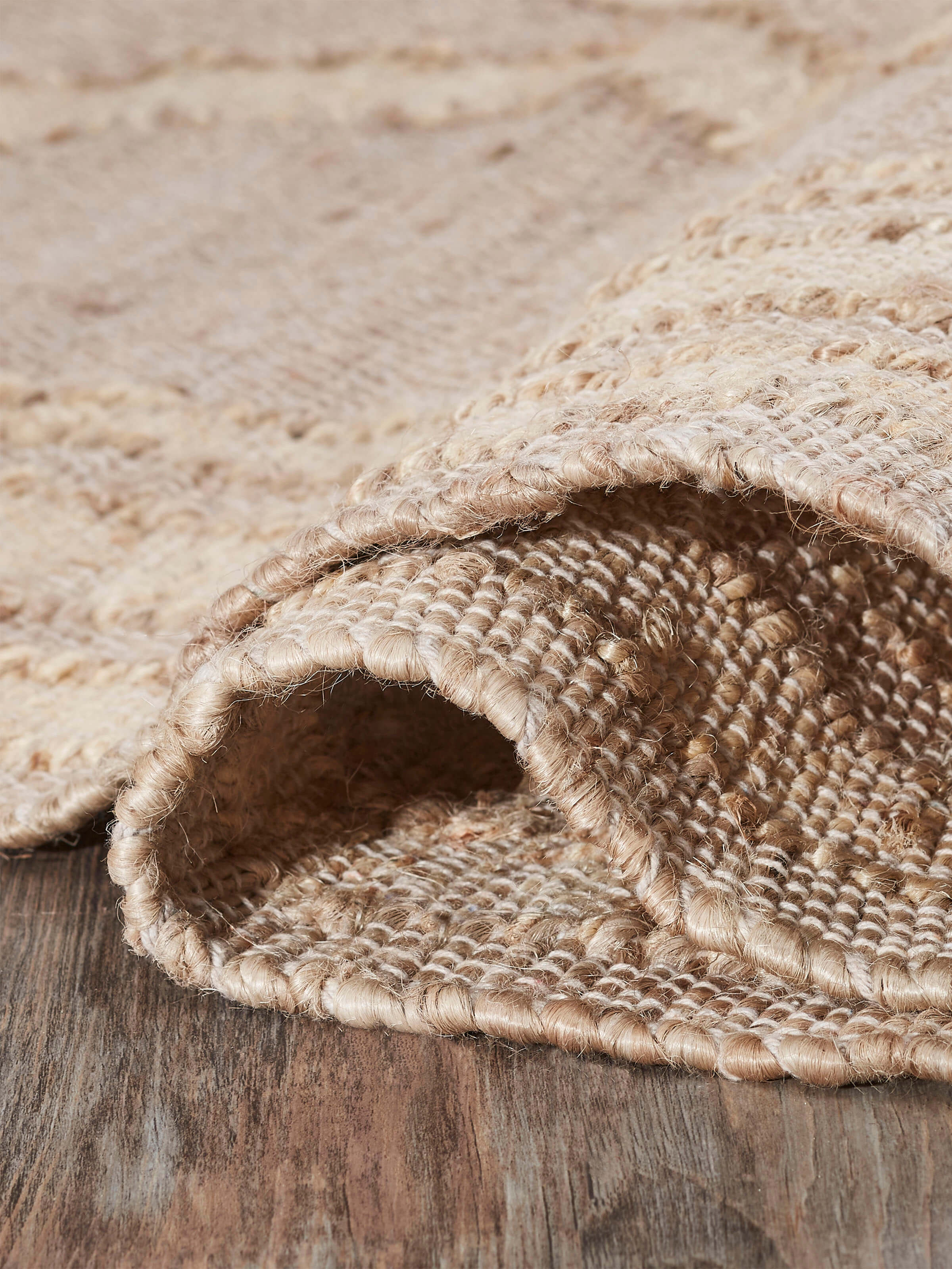 Contemporary geo beige jute & cotton natural fibre rug (5x8 ft) displayed in a setting, emphasizing its design and size.