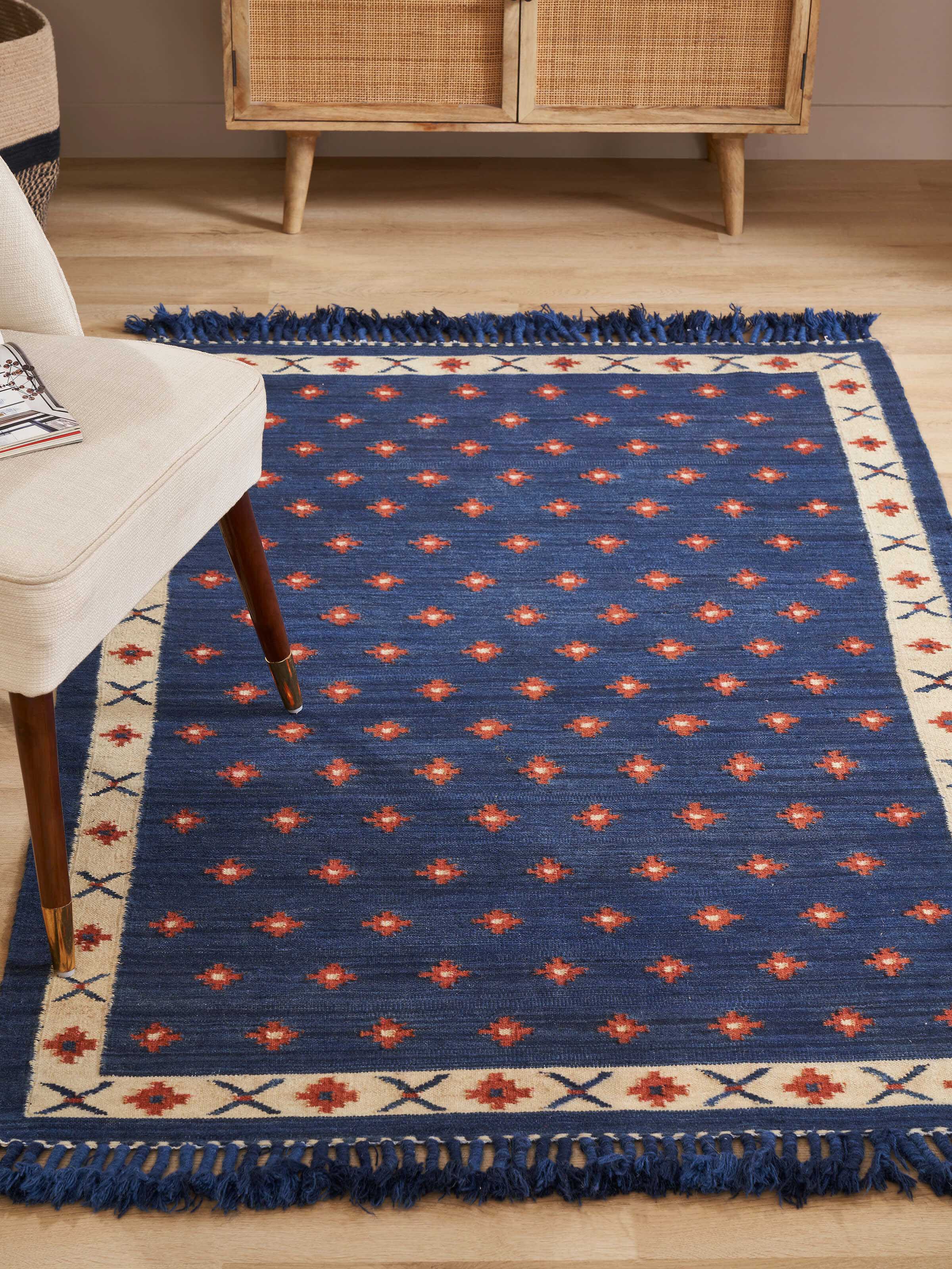 Side view of dotted diamond blue rust salawas wool & cotton panja dhurrie, highlighting the color and pattern details