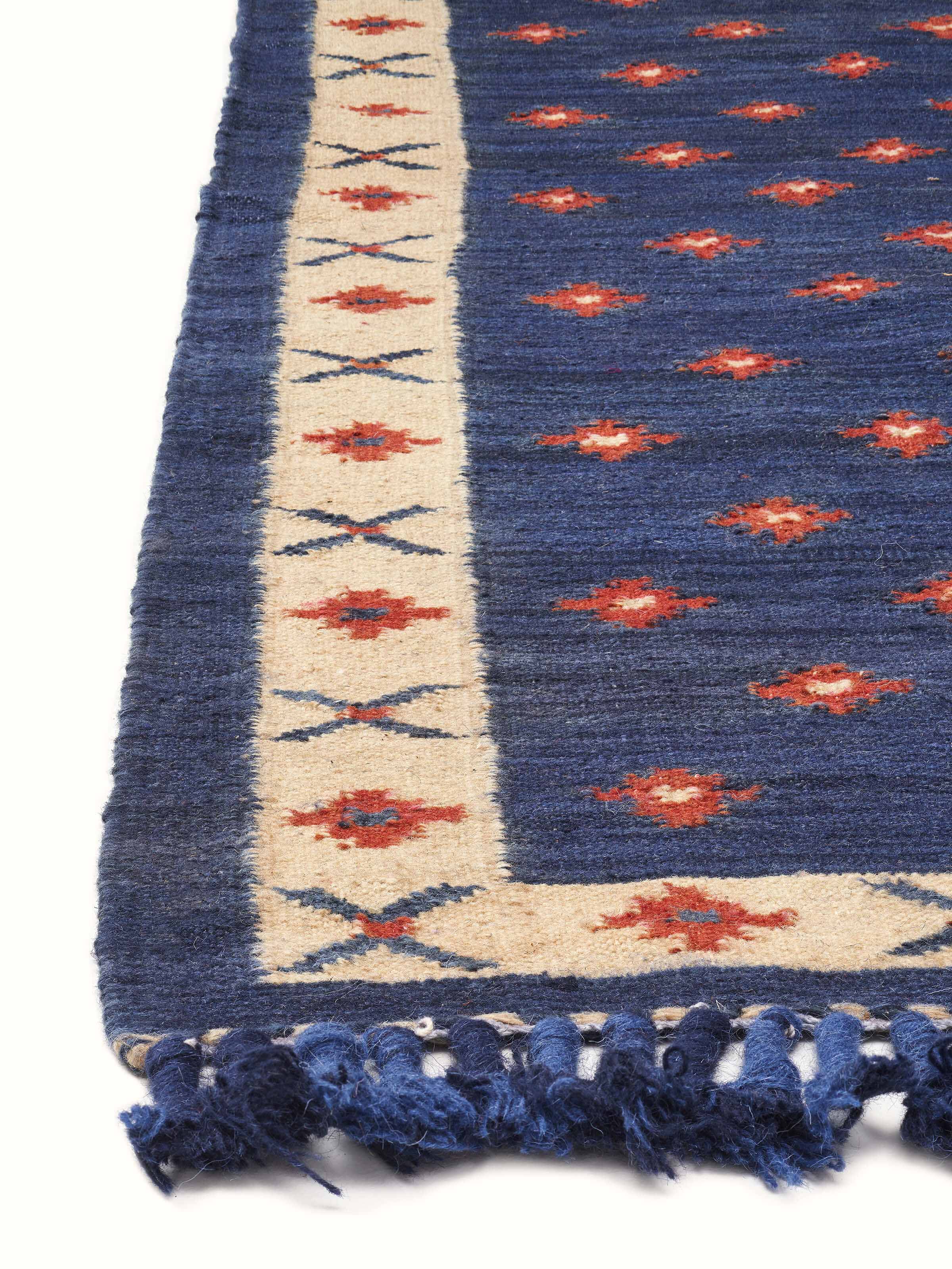 Detailed close-up of dotted diamond blue rust salawas wool & cotton panja dhurrie, focusing on the weave and texture