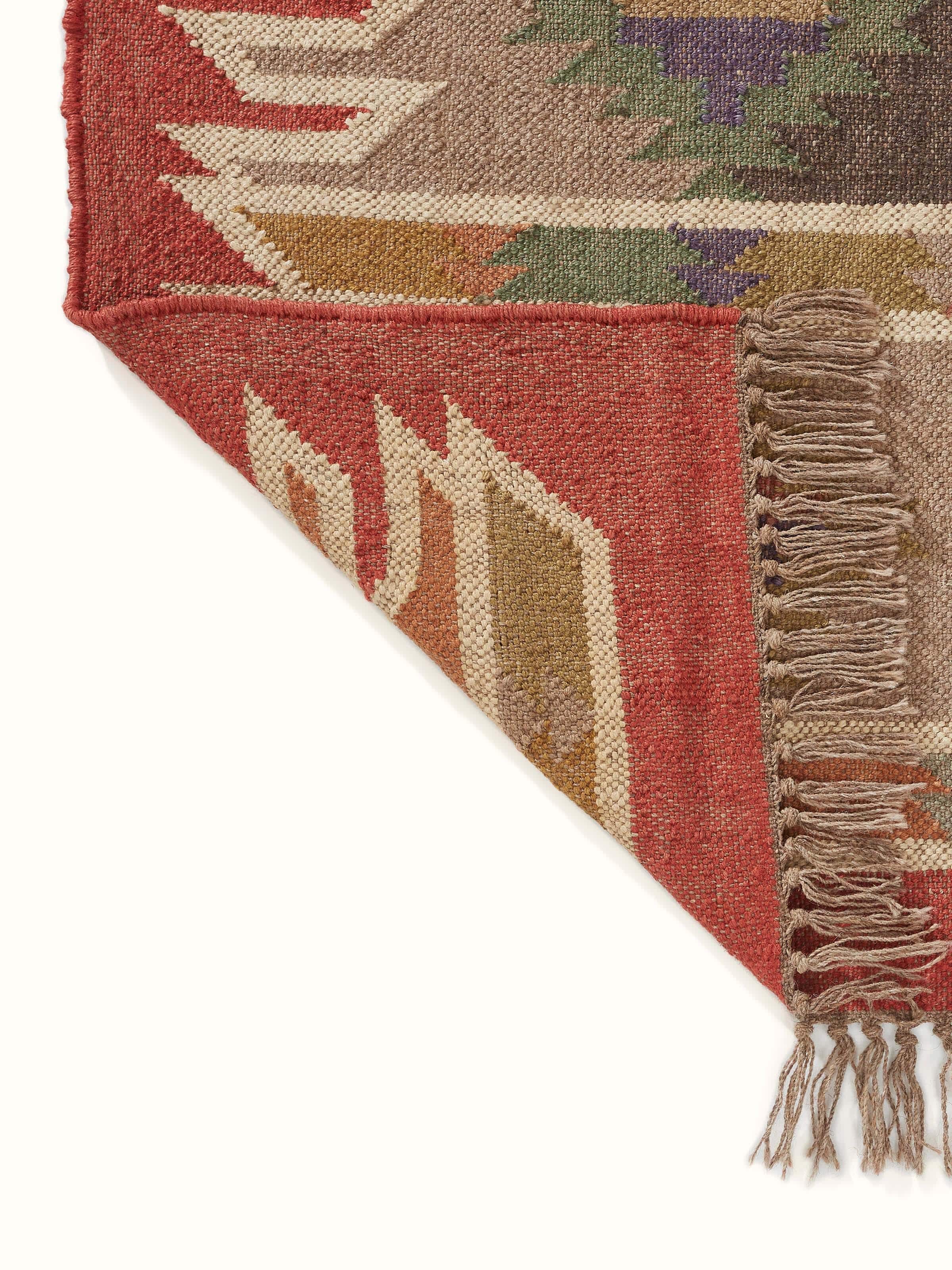 Full view of Traditional kilim rust green lawan jute & wool panja dhurrie showcasing its vibrant colors and patterns.