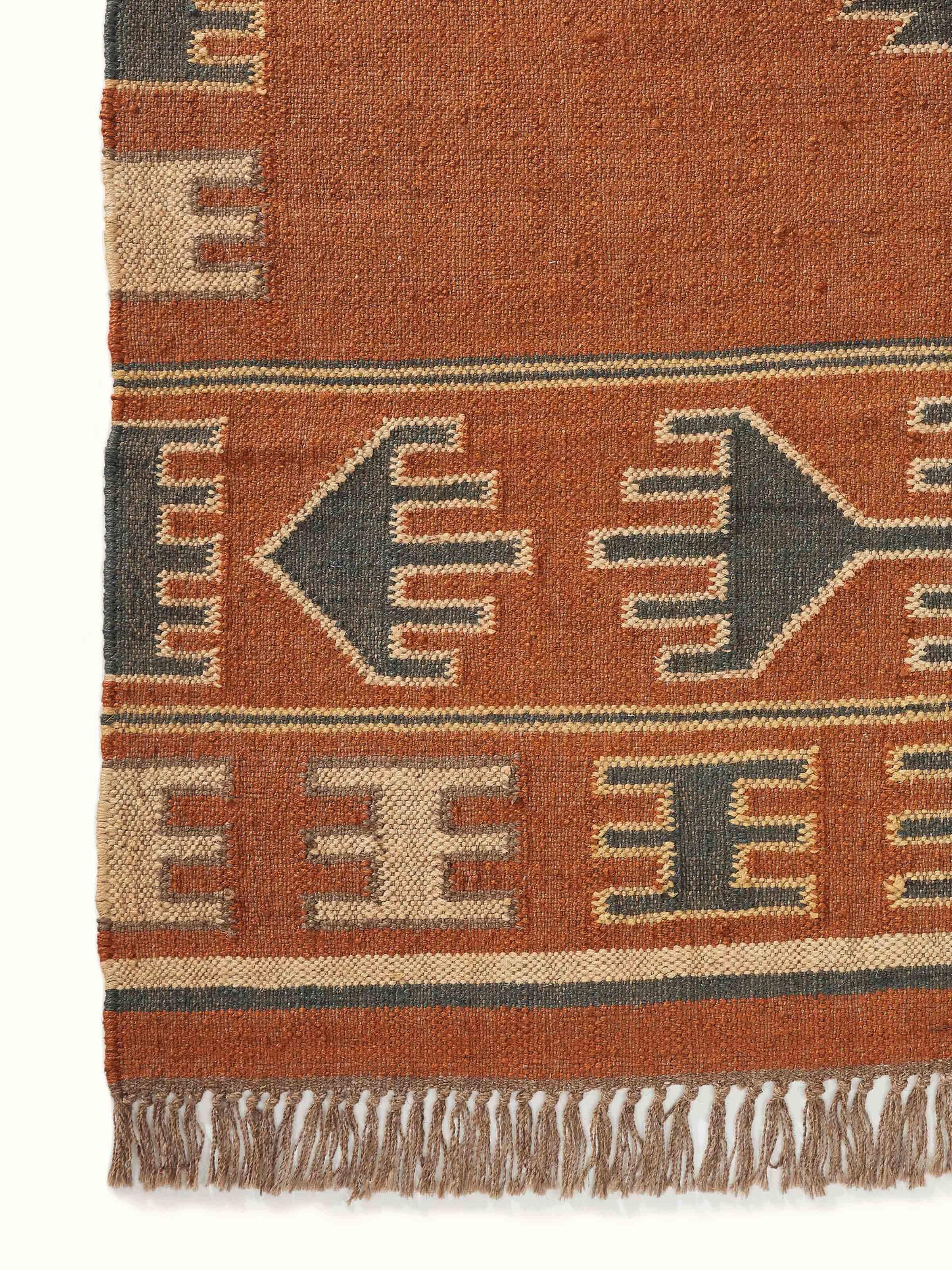Full view of Traditional Kilim rust lawan wool & jute panja dhurrie laid out, showing the complete design and size