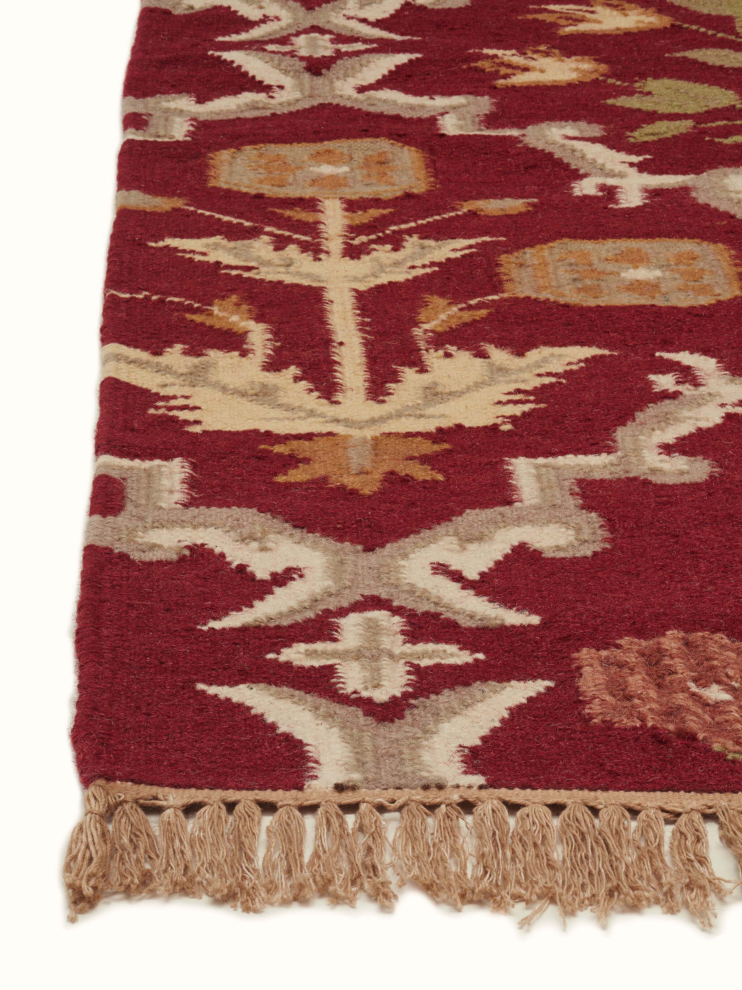 Detailed view of Traditional Mughal Floral Kilim Rust Salawas wool & cotton panja dhurrie focusing on the texture and floral design.