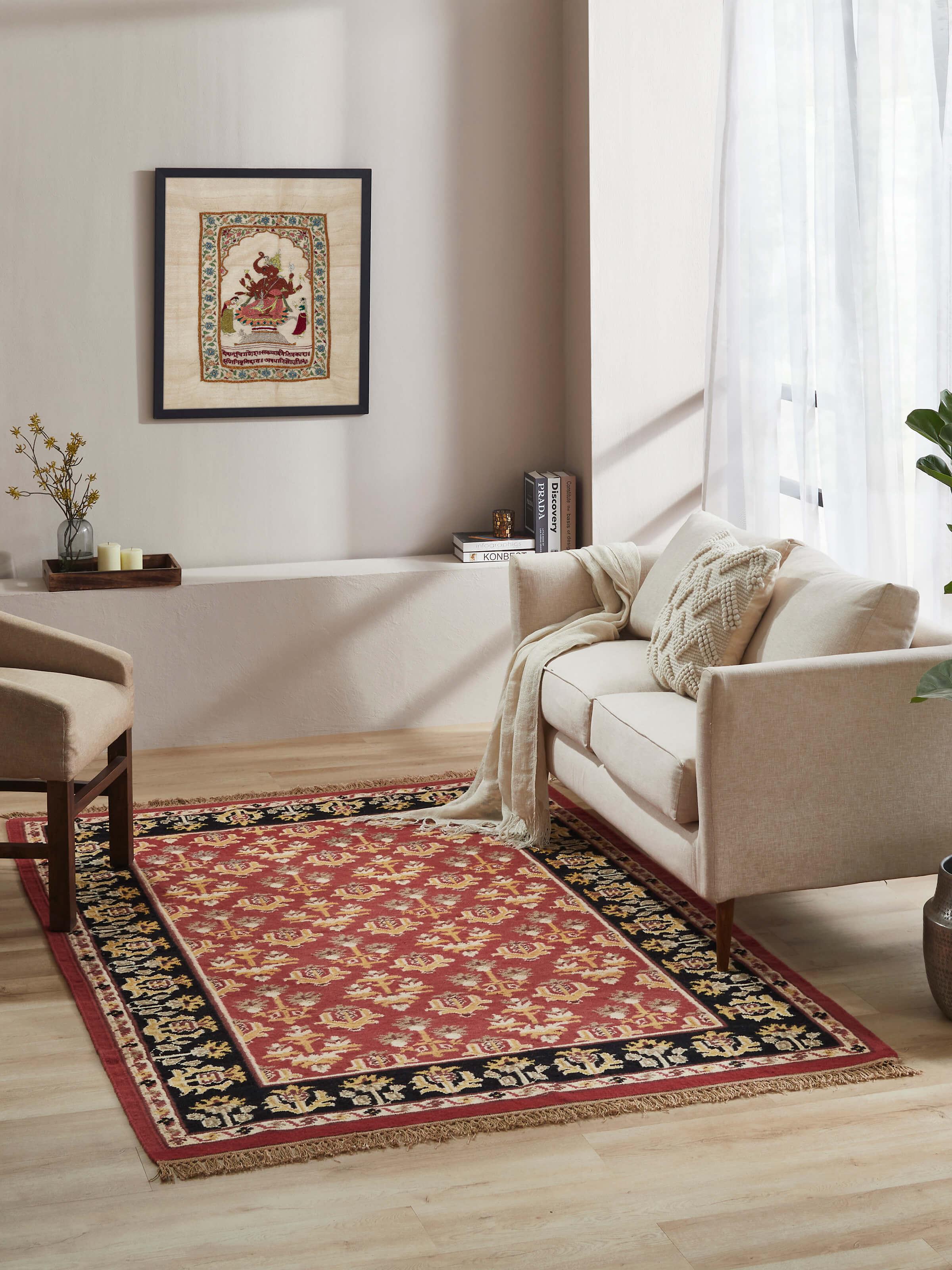 Close-up of Traditional floral kilim rust salawas wool & cotton panja dhurrie highlighting the intricate floral designs and texture