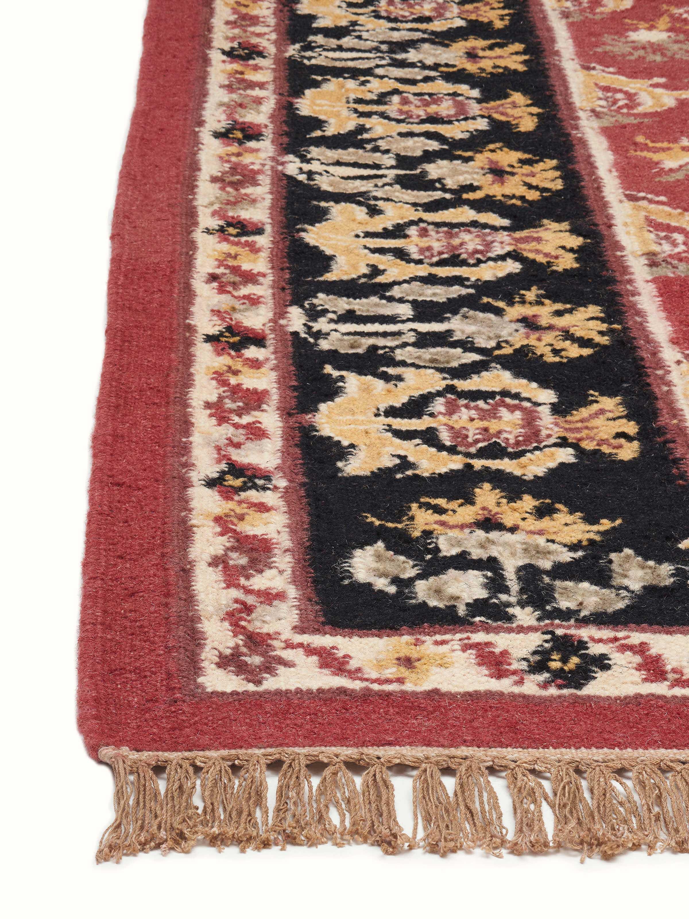 Detailed view of Traditional floral kilim rust salawas wool & cotton panja dhurrie showing the craftsmanship and color contrast