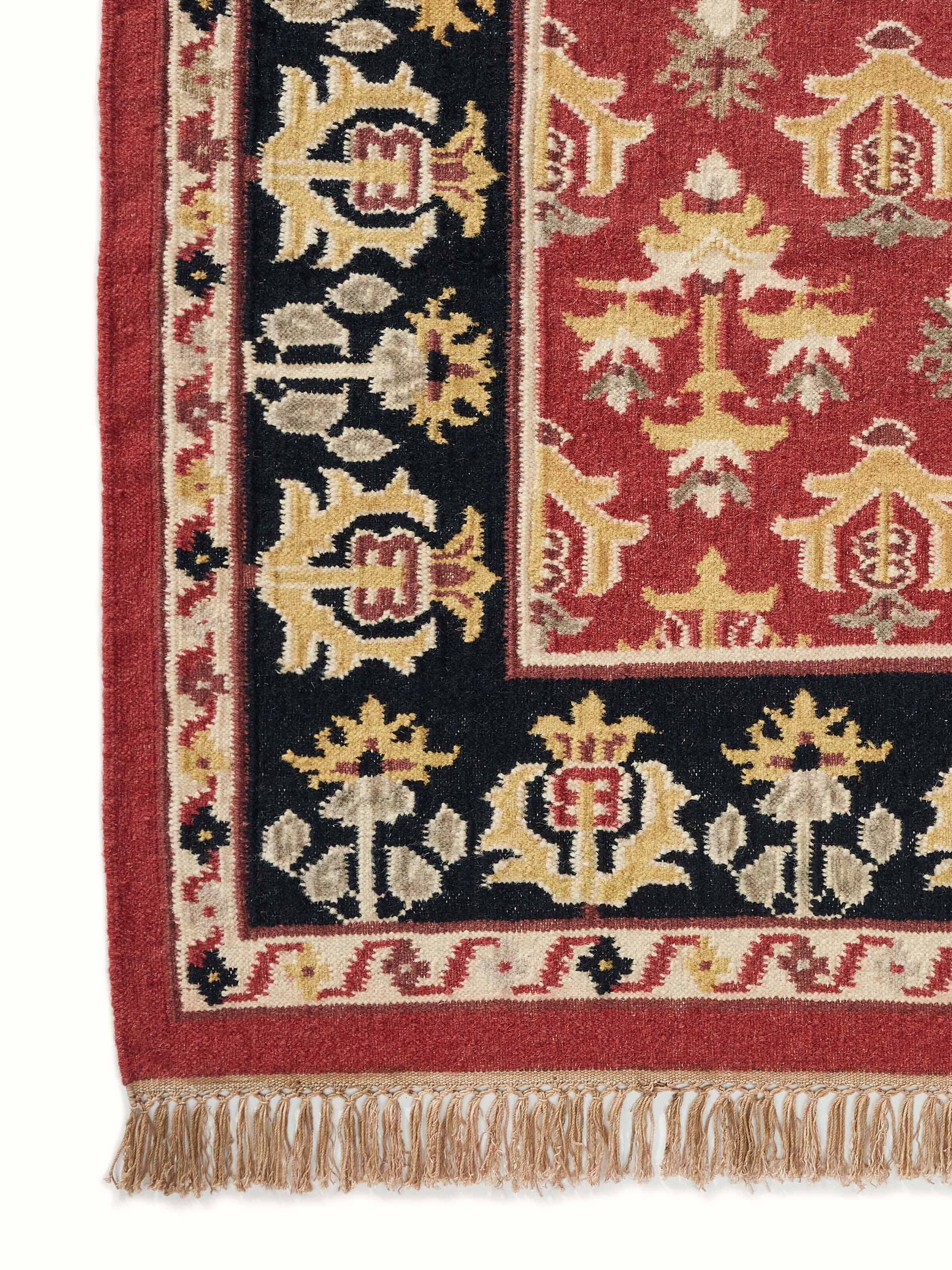 Full view of Traditional floral kilim rust salawas wool & cotton panja dhurrie spread out to display its full pattern