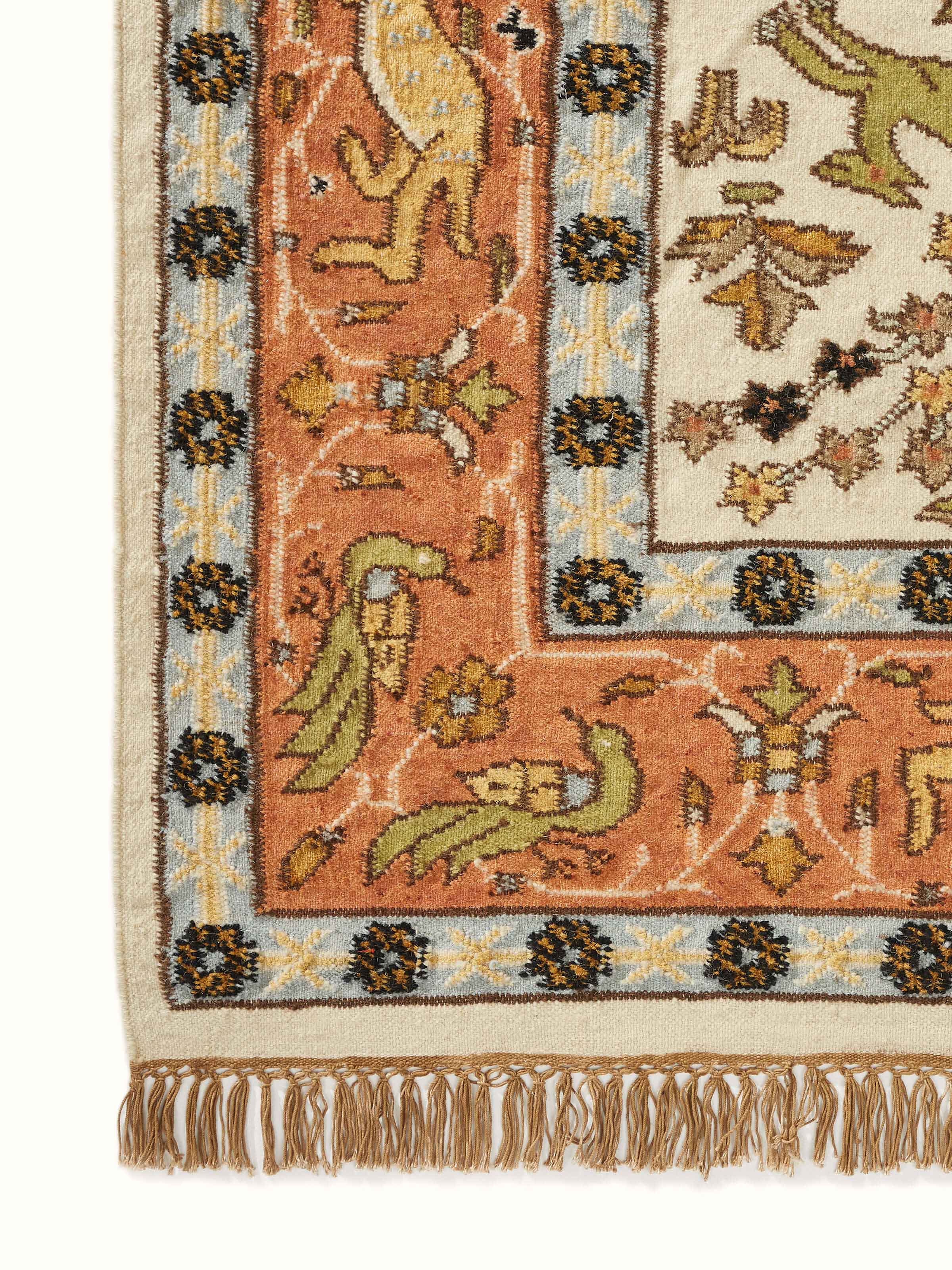 Angled view of Kilim hunting salawas wool & cotton panja dhurrie, illustrating its use and overall design in a room setting.