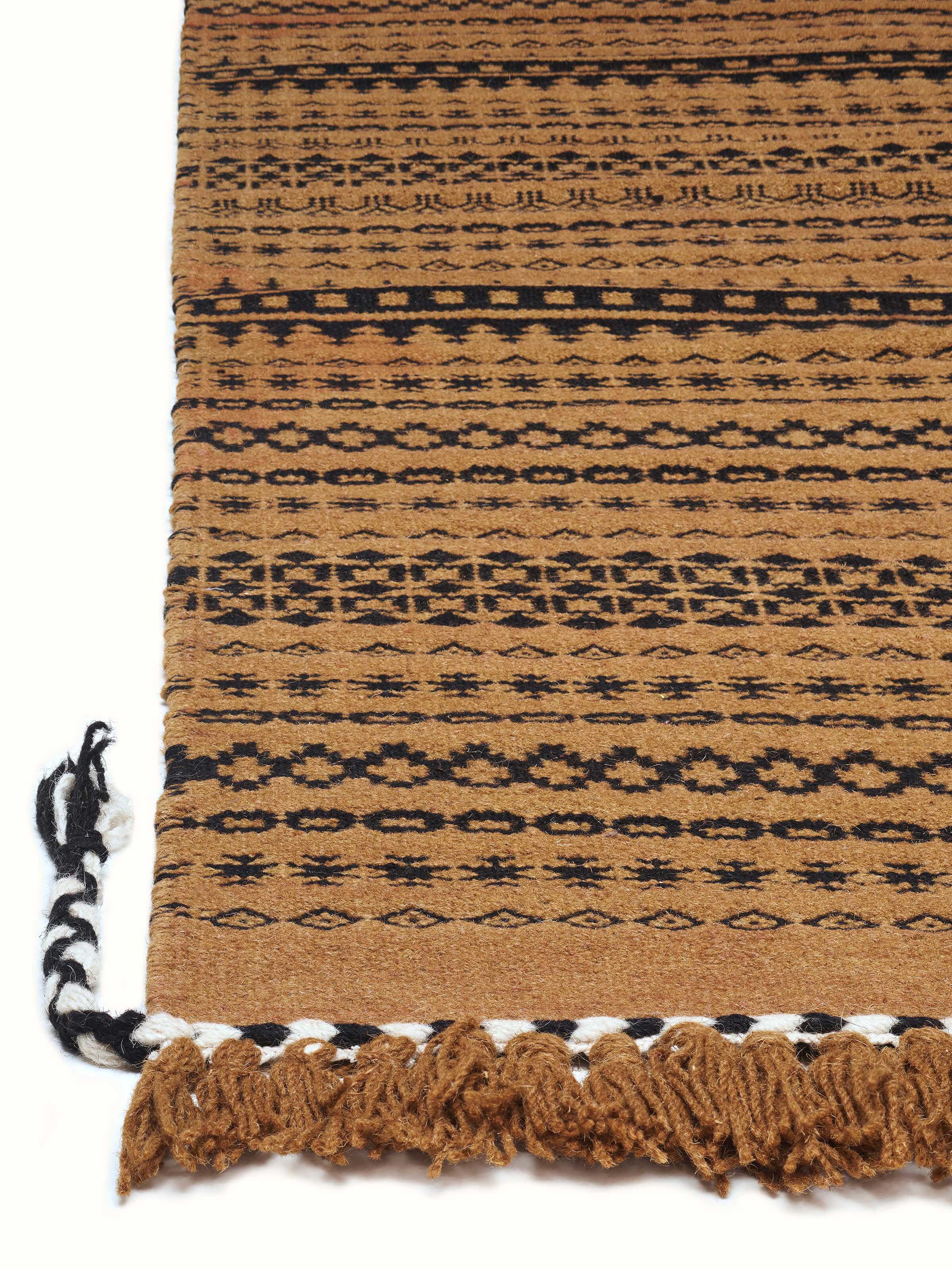 Sindhi textured orange salawas wool & cotton panja dhurrie with emphasis on the rich orange color and intricate panja weaving.