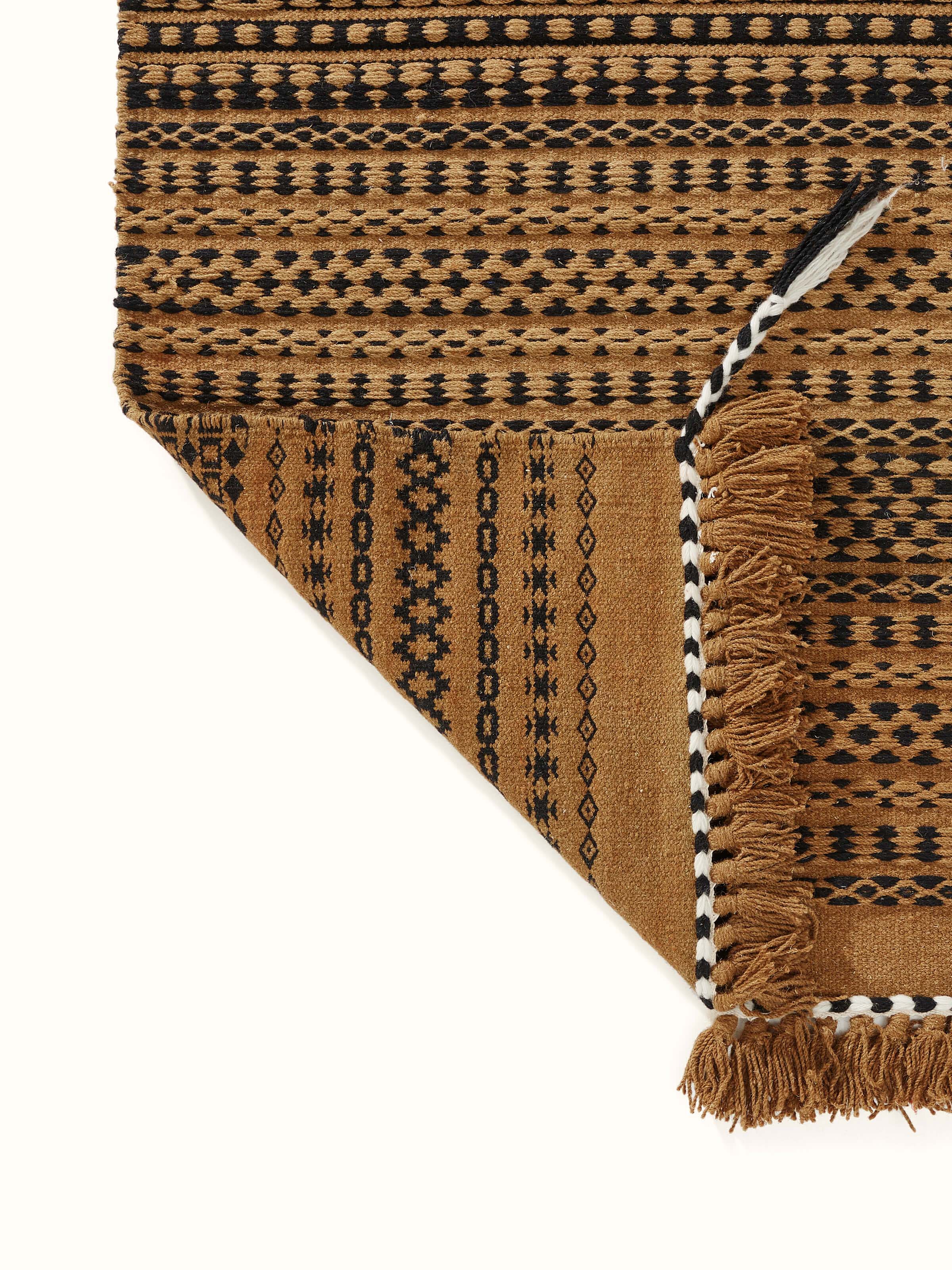 Perspective view of Sindhi textured orange salawas wool & cotton panja dhurrie, showing the full extent of the traditional weaving pattern.