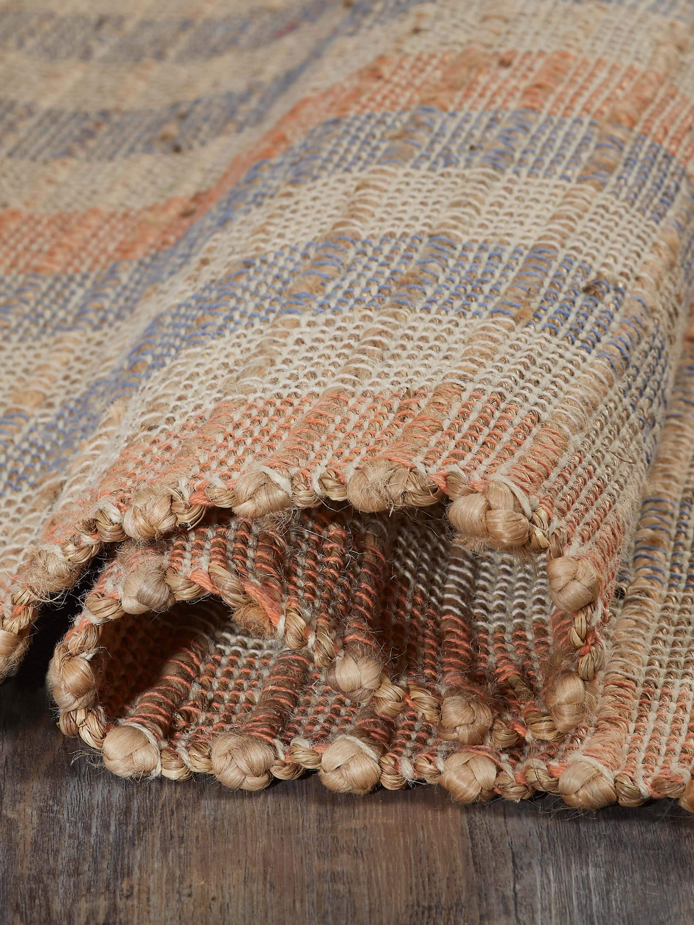 Textured beige blue lawan jute & cotton natural fibre rug shown in a setting, emphasizing its design and texture.