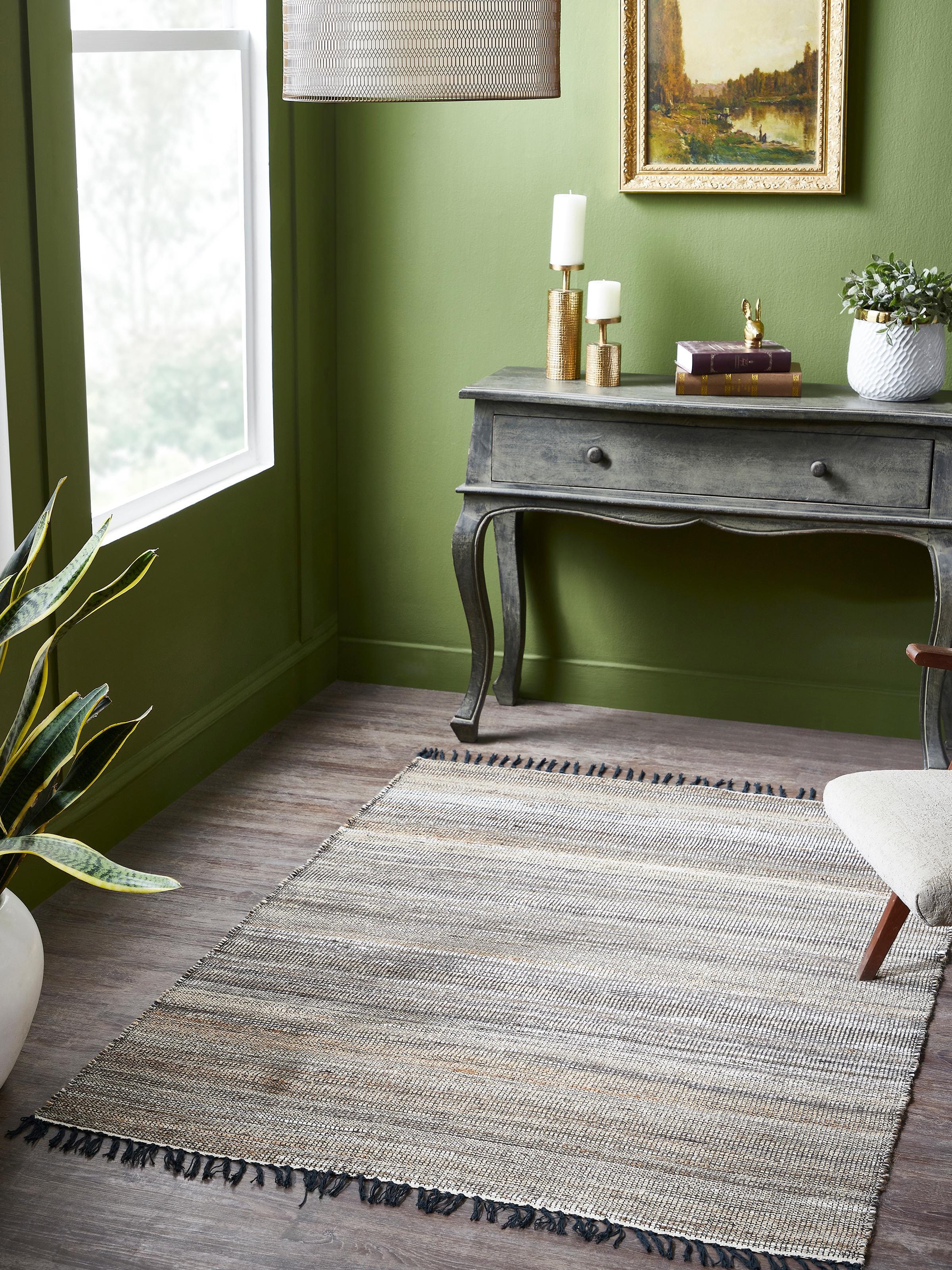 Lifestyle image of Lawan rug crafted from jute and wool, featuring a beige and charcoal textured pattern for earthy modern interiors.